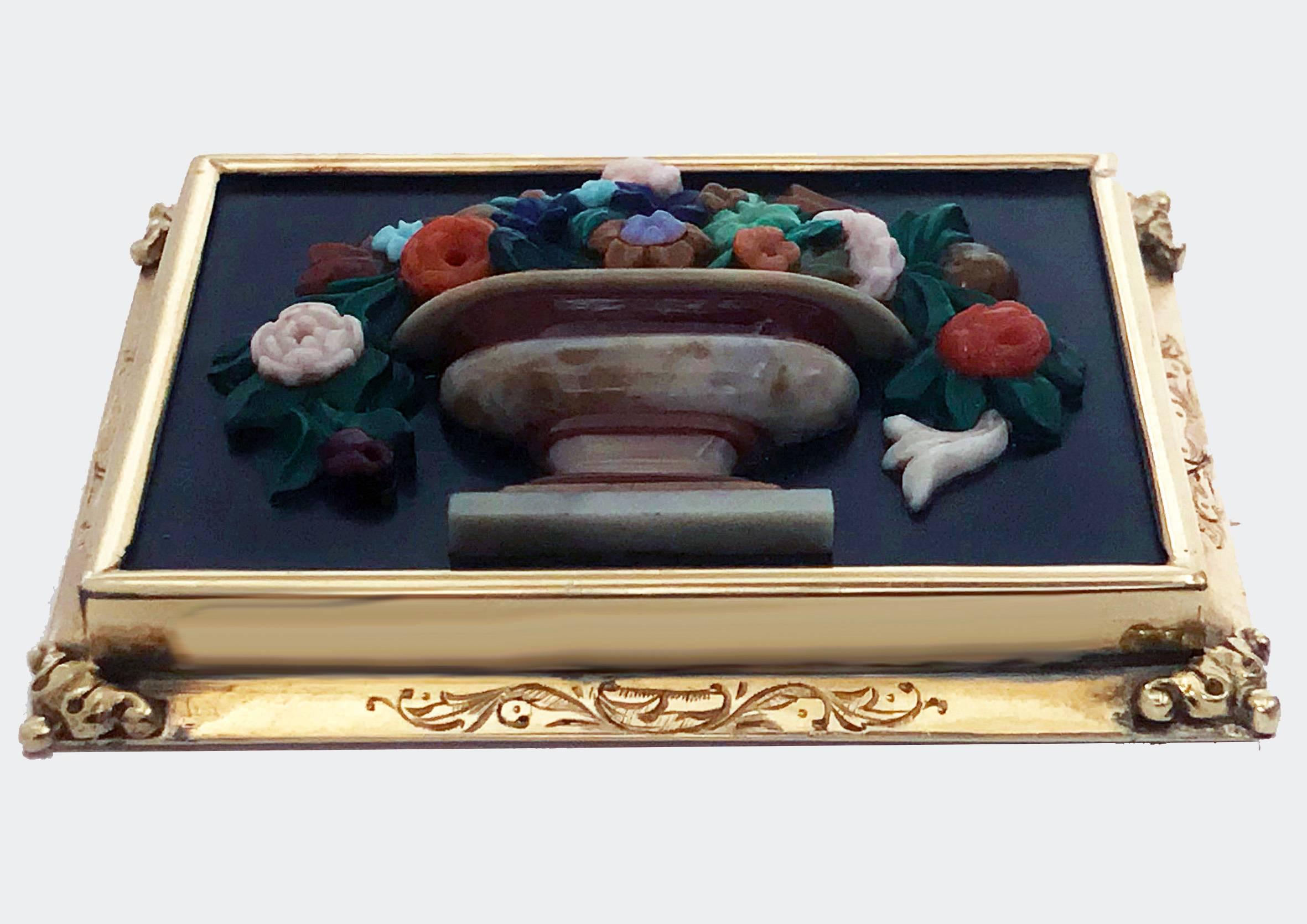 Exceptionally Fine bouquet of flowers Brooch Pin, carved chalcedony on basalt within gold frame (tests as 15K), 19th century. The rectangular plaque form Brooch with multi colour carved chalcedony agates depicting an urn shaped vase of flowers