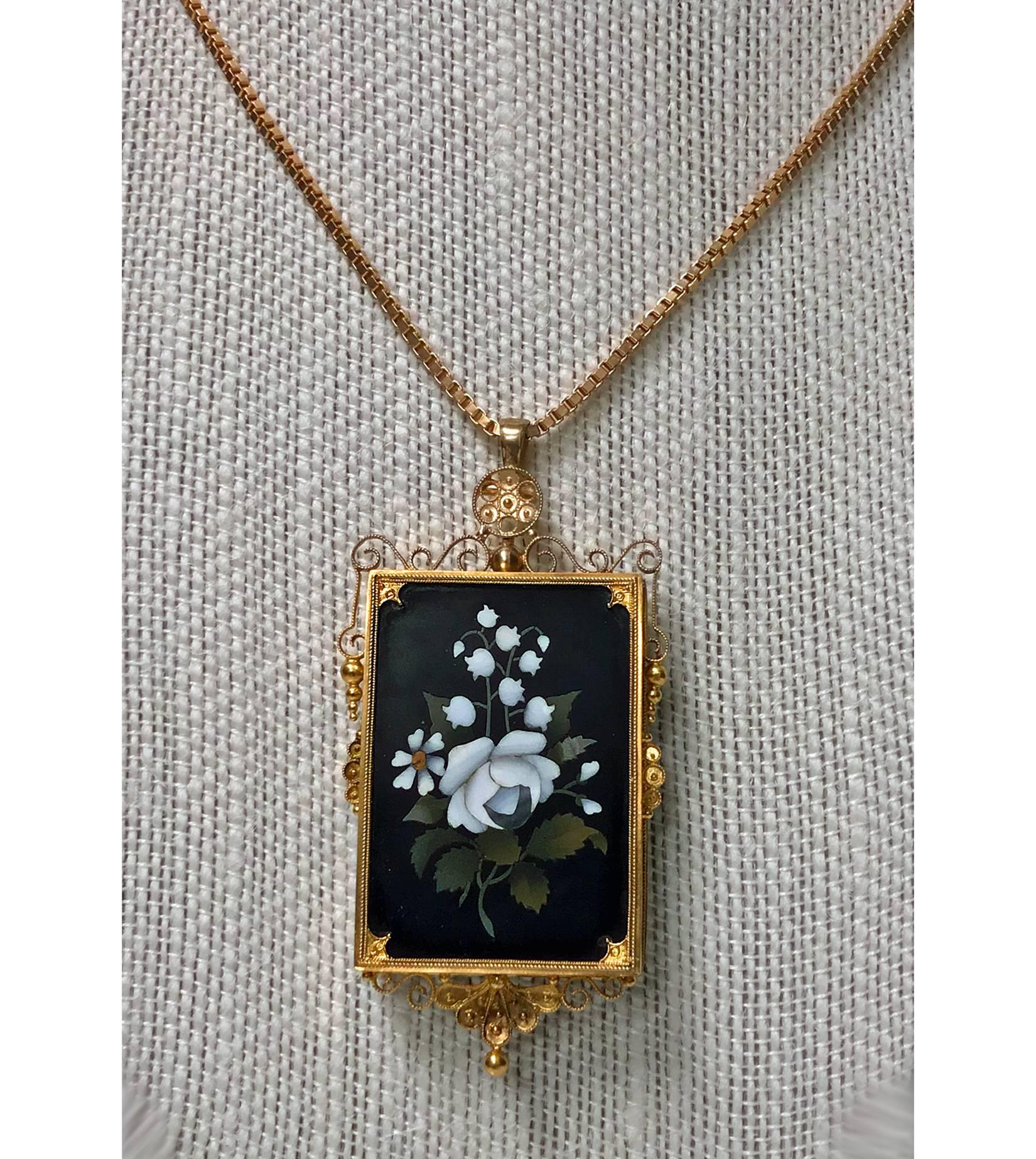 Antique Gold Pietra Dura Pendant Brooch, Italy C.1875. The Pendant Brooch of rectangular shape, fine pietra dura floral white rose inlay, the surround gold mount of scroll granular etruscan work. Gold pin to reverse and later hinged bale pendant.