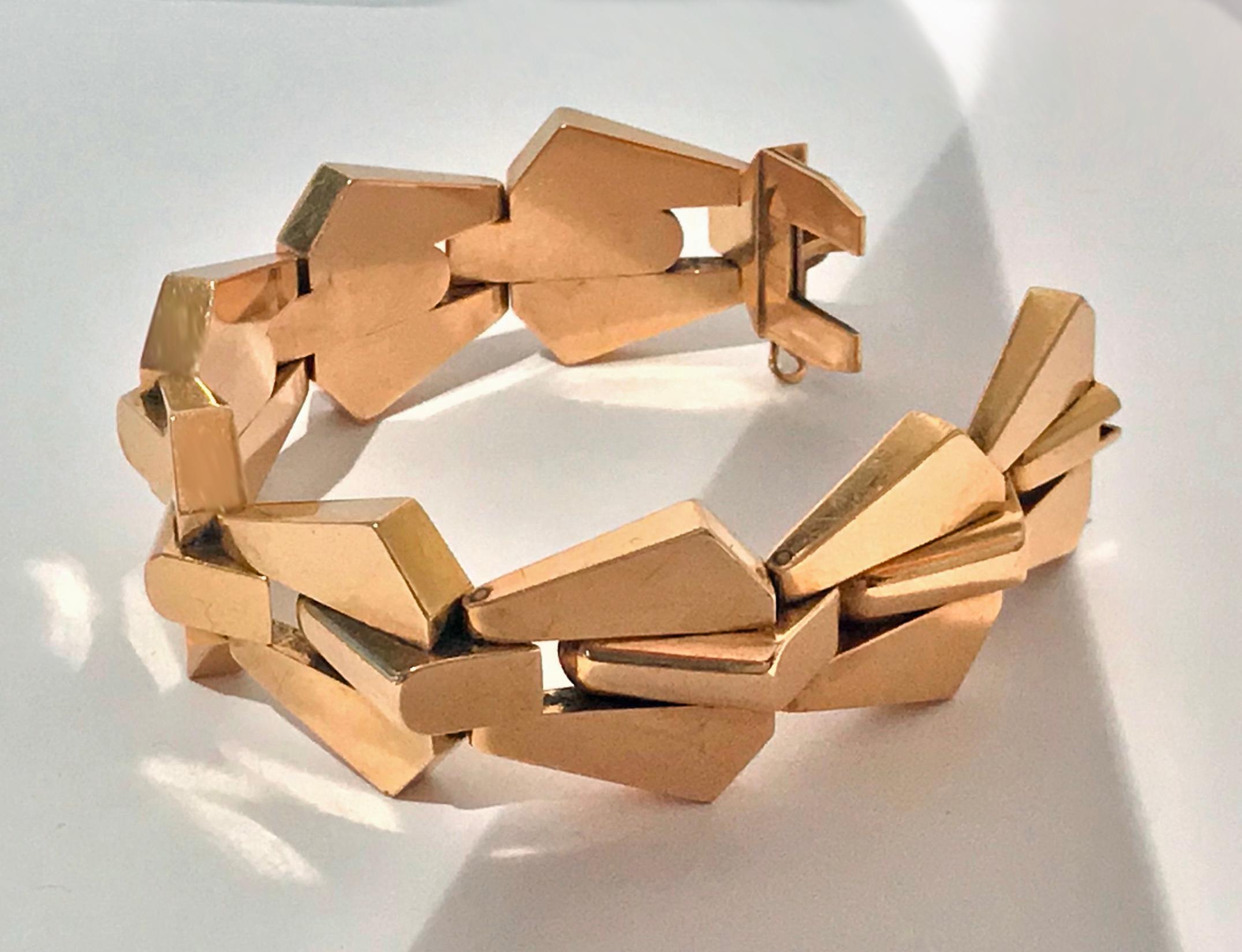 French 1940’s 18K pink Gold Bracelet. The large bracelet with fleche arrow like large hinged links. Width of links: 1.00 inches. Length: 7.50 inches. Full French eagle and makers mark LT in lozenge with fleche vertical between. Total Item Weight: