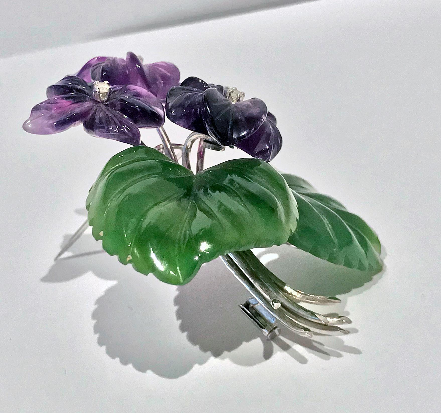 Large Carved Nephrite, Amethyst and Diamond 14K Brooch, Austria C.1950. The brooch with four foliate amethyst colour flowers, inset with four single cut diamonds, the surrounding foliage of large carved nephrite leaves, all surmounted on white gold