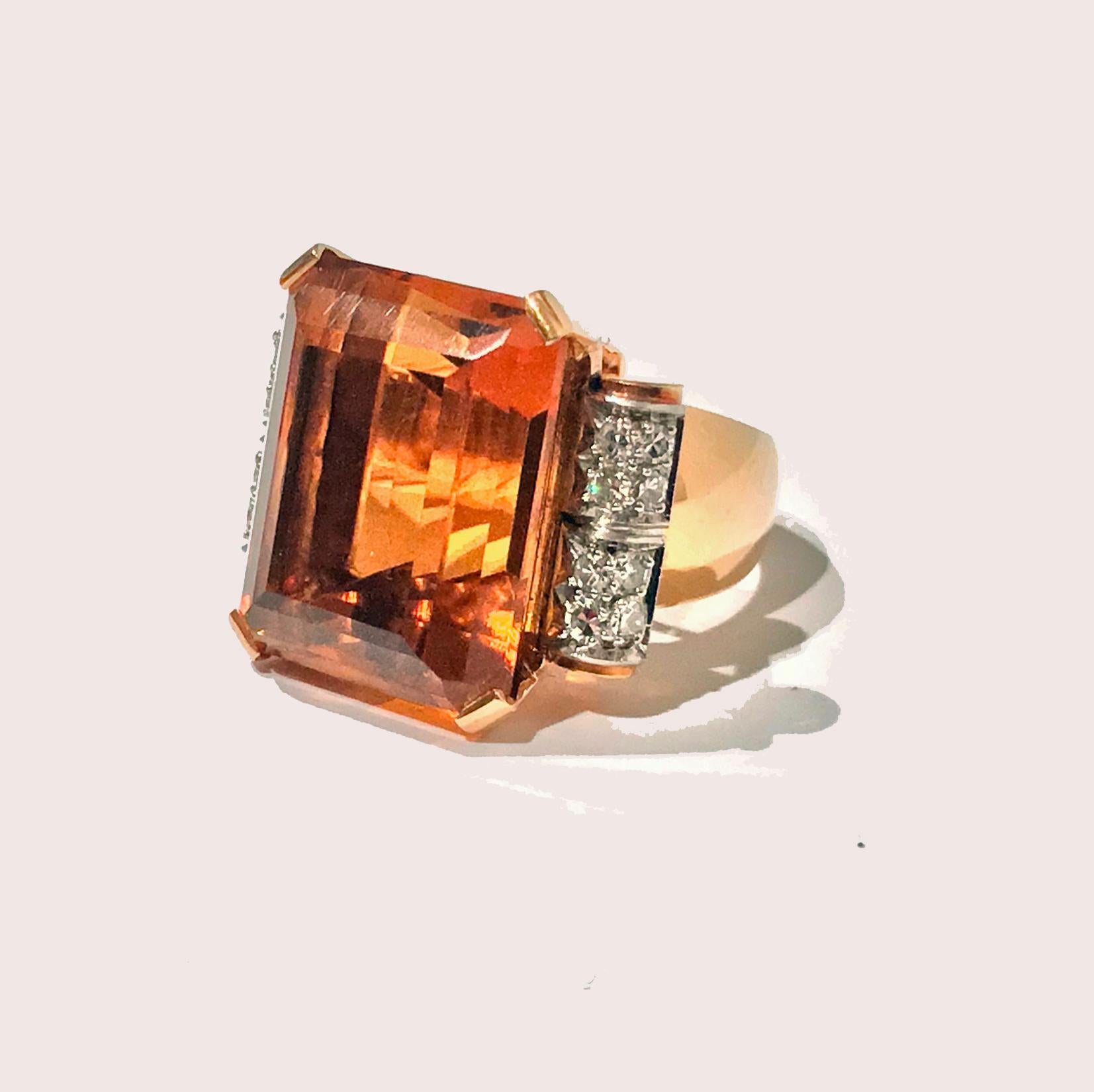 18K Citrine and Diamond Ring, French owl import mark, 20th century. The ring set with a large deep sherry orange rectangular step cut citrine, gauging approximately 20 x 18 x 12 mm, flanked on each side with eight single cut diamonds surmounted on