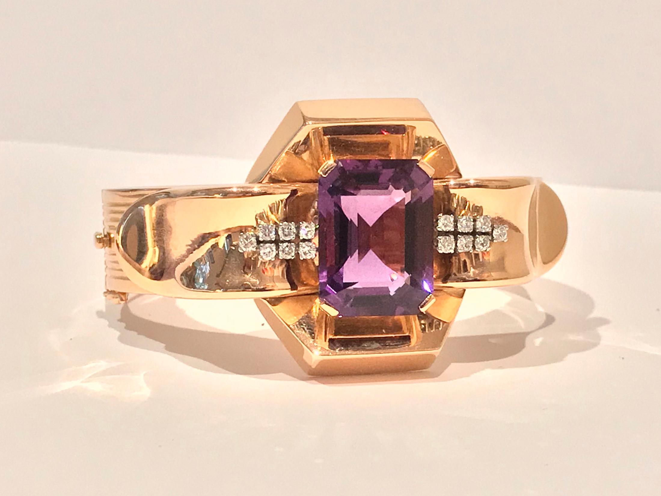 Large 18K Amethyst and Diamond Bangle, mid 20th century, French owl import and 18K marks. The hinged bangle set in the center with a fine rectangular emerald cut purple amethyst, gauging approximately 21.0 x 15.5 mm and accepted on each side with