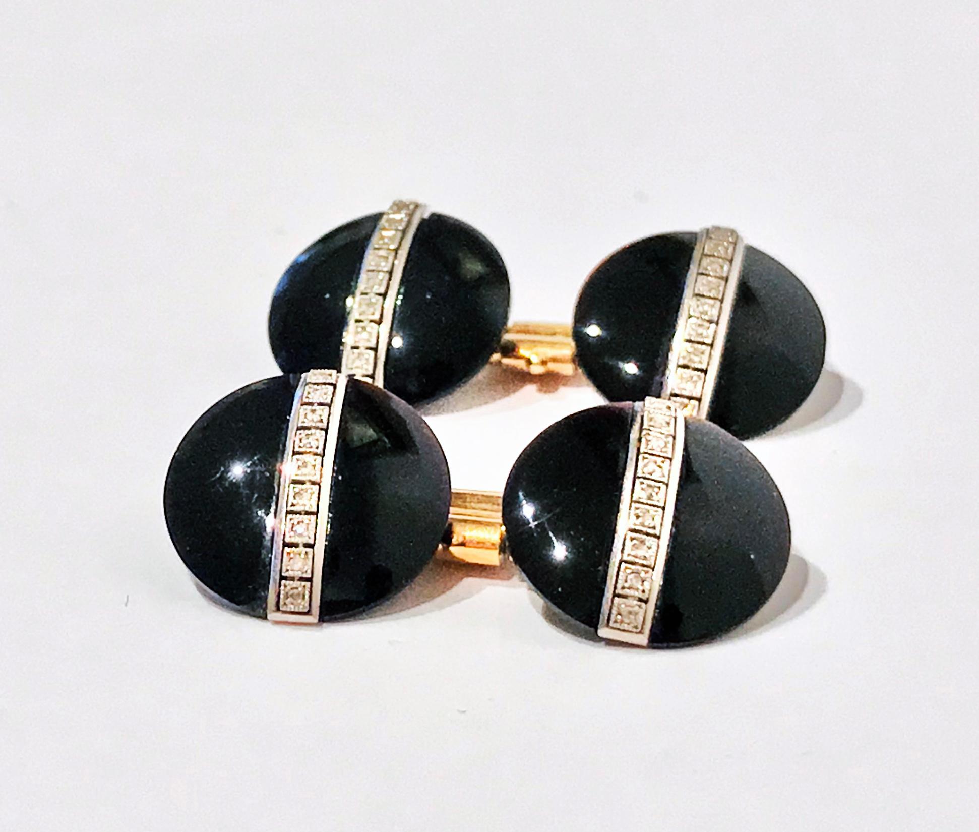 Pair of Art Deco 14K Onyx and Diamond Cufflinks, C.1930. The double-sided cufflinks of circular black onyx button style, gauging approximately 15 mm diameter, each part with a central band of nine milligrain set rose cut diamonds, gold crimped chain
