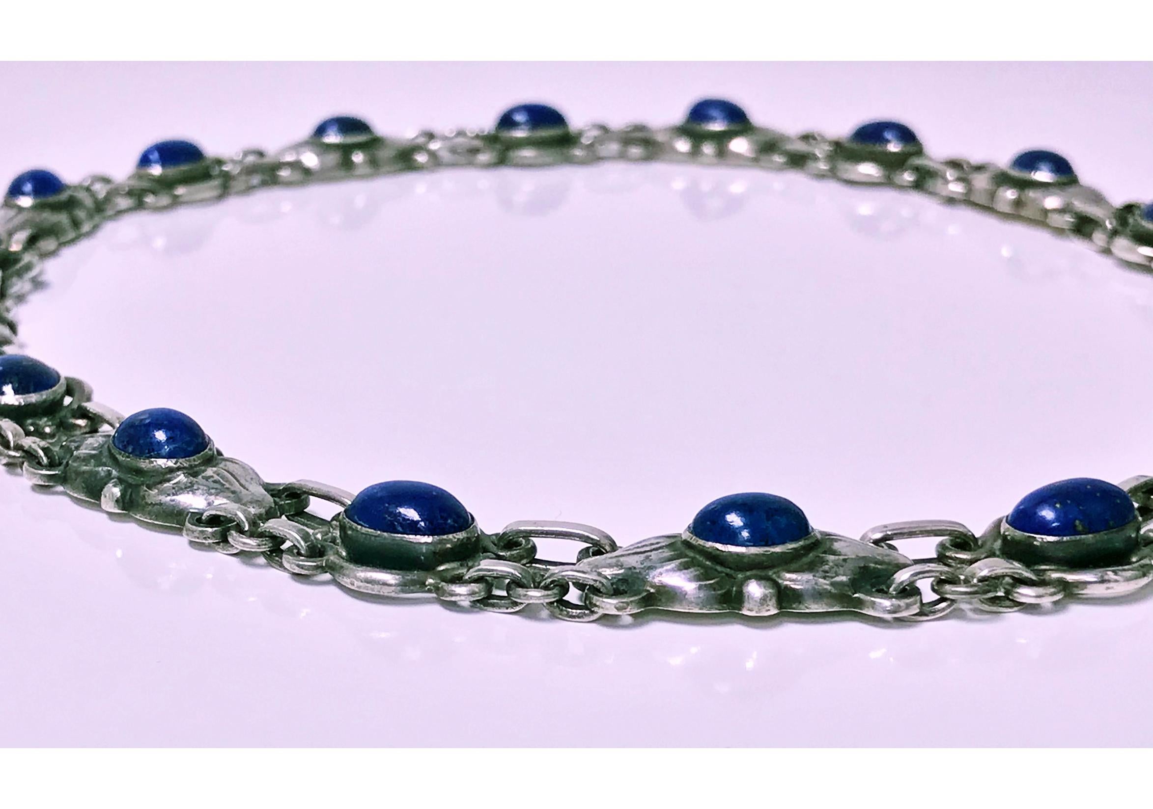 Georg Jensen Lapis and Sterling Silver Necklace, design No 57, C.1930. Bezel set oval lapis with stylised leaves. Full Jensen marks and GI marks to reverse. Design featured in Georg Jensen Jewelry, Isabelle Anscombe, edited by David A. Taylor. Yale