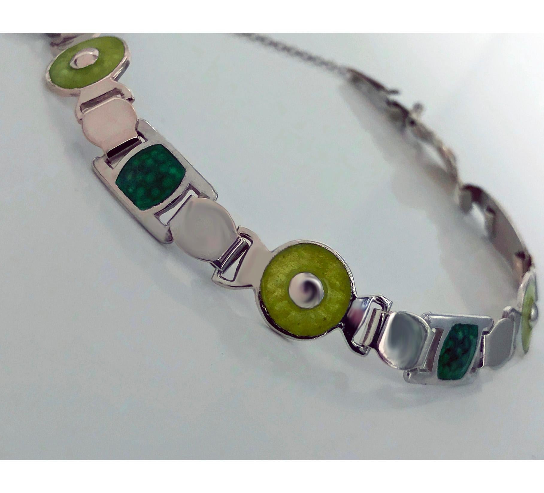 English Arts and Crafts Silver and Enamel Bracelet, Birmingham 1909 James Fenton The Bracelet with ovoid, circular and rectangular green and lime enamel sections interspaced with plain polished silver slightly ovoid links, terminating with a