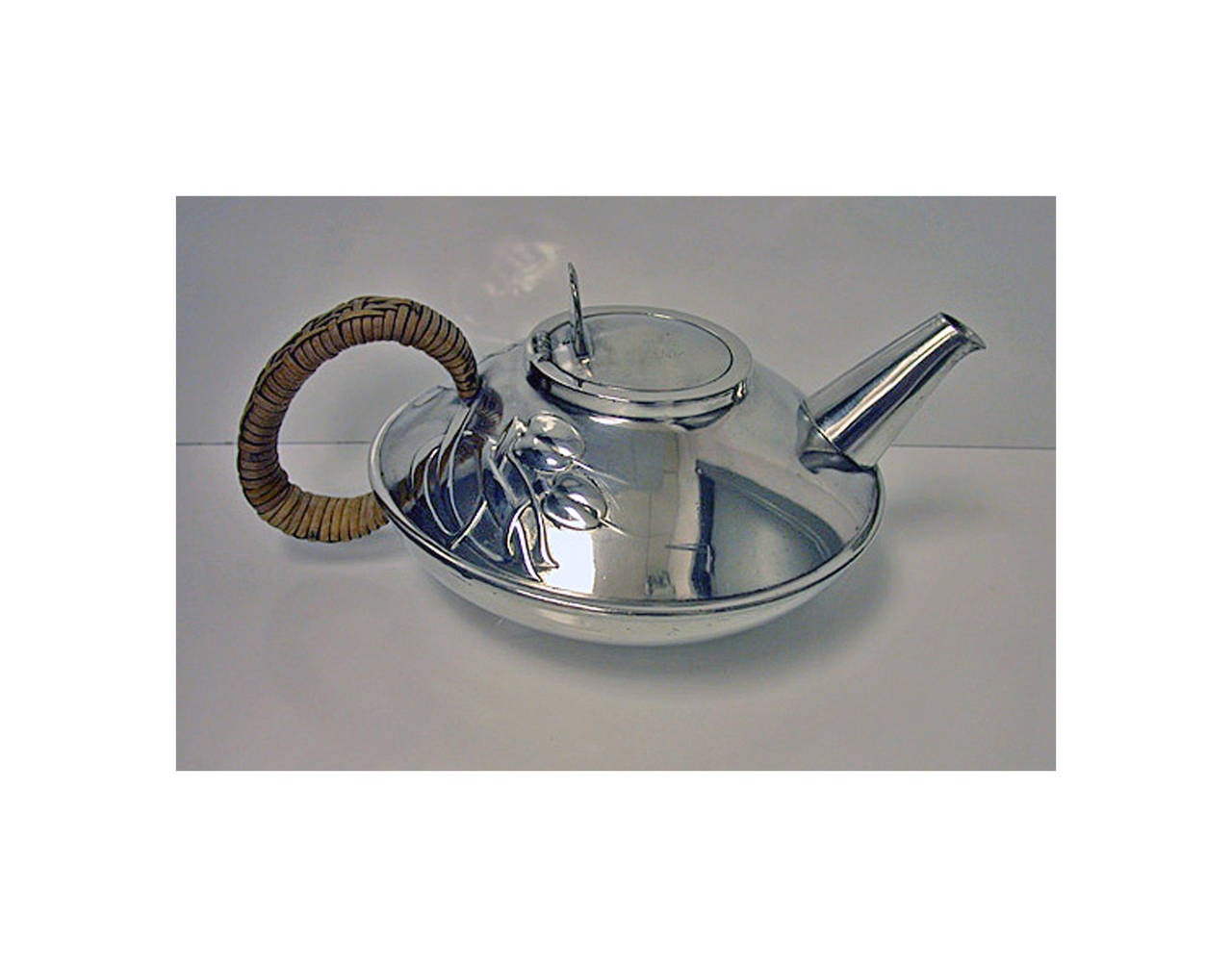 Archibald Knox Liberty Tudric pewter Tea set and Tray, C.1905.Teapot, cream jug, sugar and tray, each with relief whiplash curved celtic ornament interlace decoration, original wicker handle to teapot, together with two handled rectangular tray.