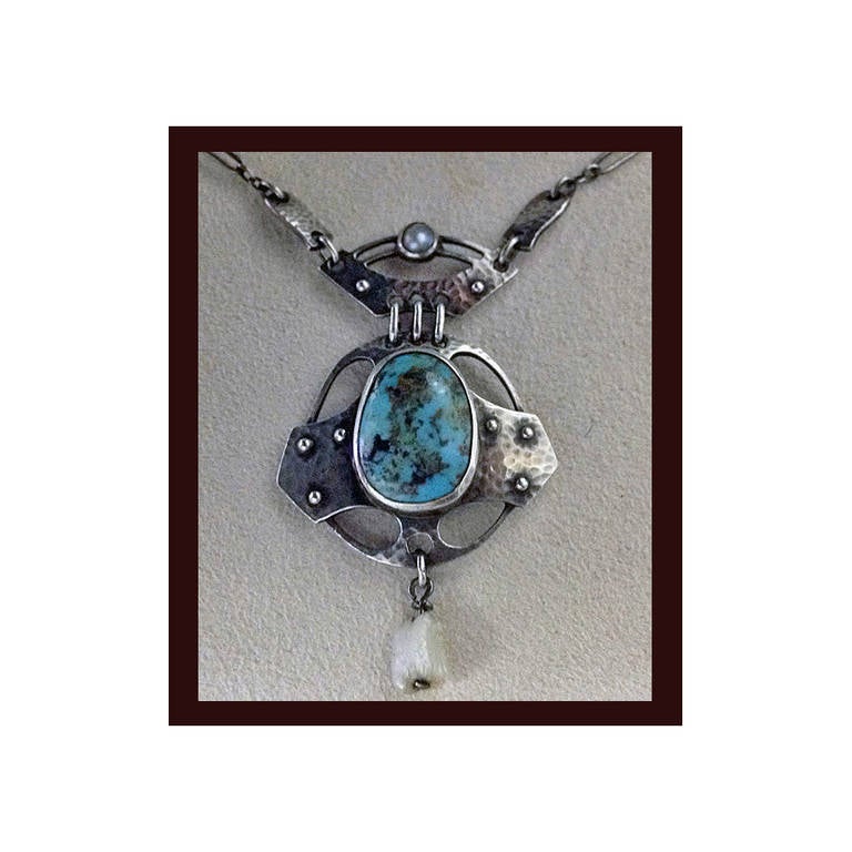 Rare Wilhelm Fühner, Pforzheim, Arts & Crafts hammered silver pendant with mother-of-pearl, matrix turquoise and pearl drop. Germany, C. 1900. The pendant with hammered and rivet design, bezel set with oval turquoise cabochon. Marked to reverse 950