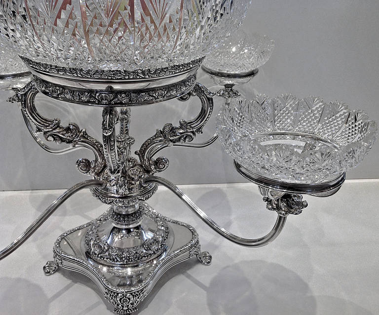 Old Sheffield Epergne, English C.1830.The square stand on 4 foliage knuckle supports, gadroon foliate rim, base and central section of rich foliage design  and central finial, supporting a large bowl, hob nail design, fan border, 4 reeded arms