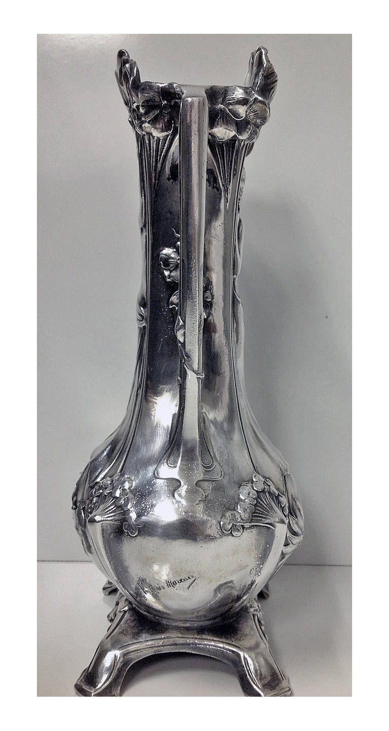 Art Nouveau Vase, Paris C.1900 on four turned bracket feet, depicting on the front and back side and reverse full figure views of semi-nude young women respectively. The vase with surround of poppy foliage, the open handles conforming. Signed lower