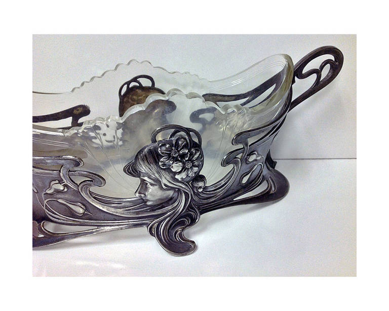 WMF Art Nouveau Jugendstil Silver plate on pewter centrepiece, Germany C.1900. The centrepiece with Art Nouveau maiden decoration, original engraved glass liner. Marks: AS WMFB. Measures: 12 x 4 x 4 ¼  inches. Illustrated WMF 1906 Catalogue page 366