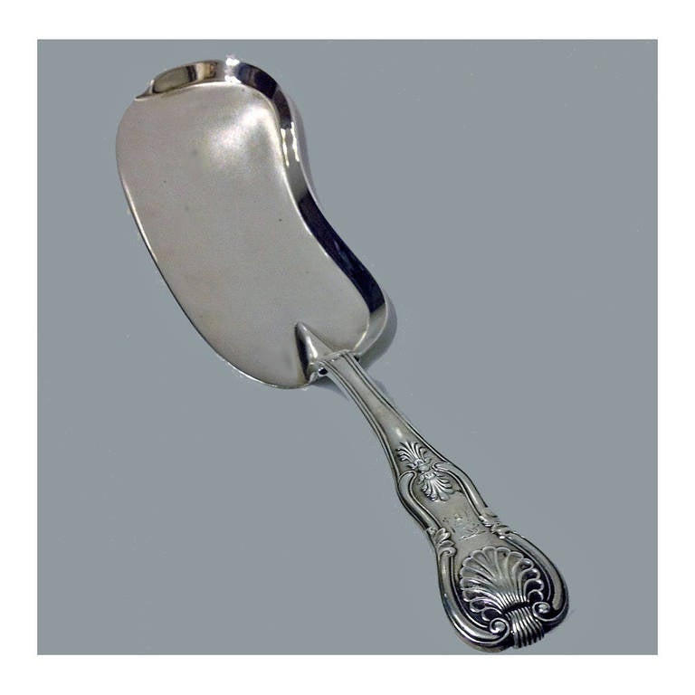 Rare Irish Silver Slice or Crumb Scoop, Dublin 1855, John Smyth. The Crumber of Kings pattern, engraved crest of a mermaid holding a sword and sceptre. Length: 13 inches. Weight: 9.75 oz.