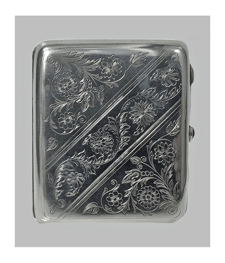 Russian Silver cigarette case, Yu. H. A, (Cyrillic) Moscow 1927-54, 875 std. The front cover with branch foliage decoration, the thumb-piece set with an oval red cabochon. Measures: 4.25 x 3.5 inches. Item Weight: 169.16 grams.