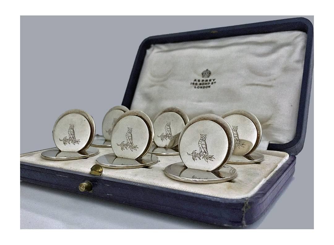 Set of 6 Silver Place Card Holders, London 1931, Asprey & Co. Original fitted box. Each of circular disc like form, engraved with the crest of an owl. All fully hallmarked and stamped Asprey London. Measures: 1.25 x 1.0 inches. Total Item Weight: