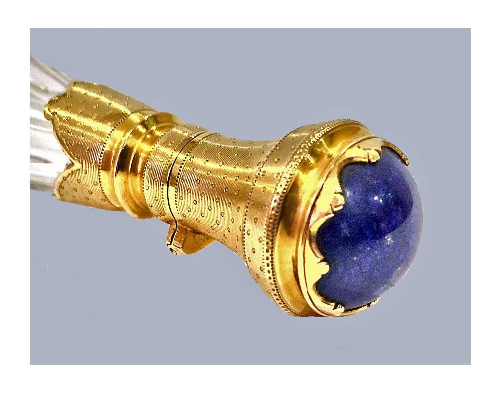 French Gold and Lapis Lazuli glass scent bottle, C.1880. The hinged top gold lid set with cabochon lapis lazuli and collar decorated with pin prick decoration against stippled background, flattened oval faceted glass body, with original stopper.