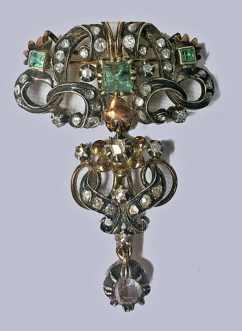 18th Century Emerald and Diamond Brooch, Portugal or Spain C.1780. Silver and Gold, claw collet set foil back rose cut diamonds and three square cut emeralds , detachable drop. Later pin. Brooch measures: 2 x 1.5 inches. Total Item Weight: 14.8 gm