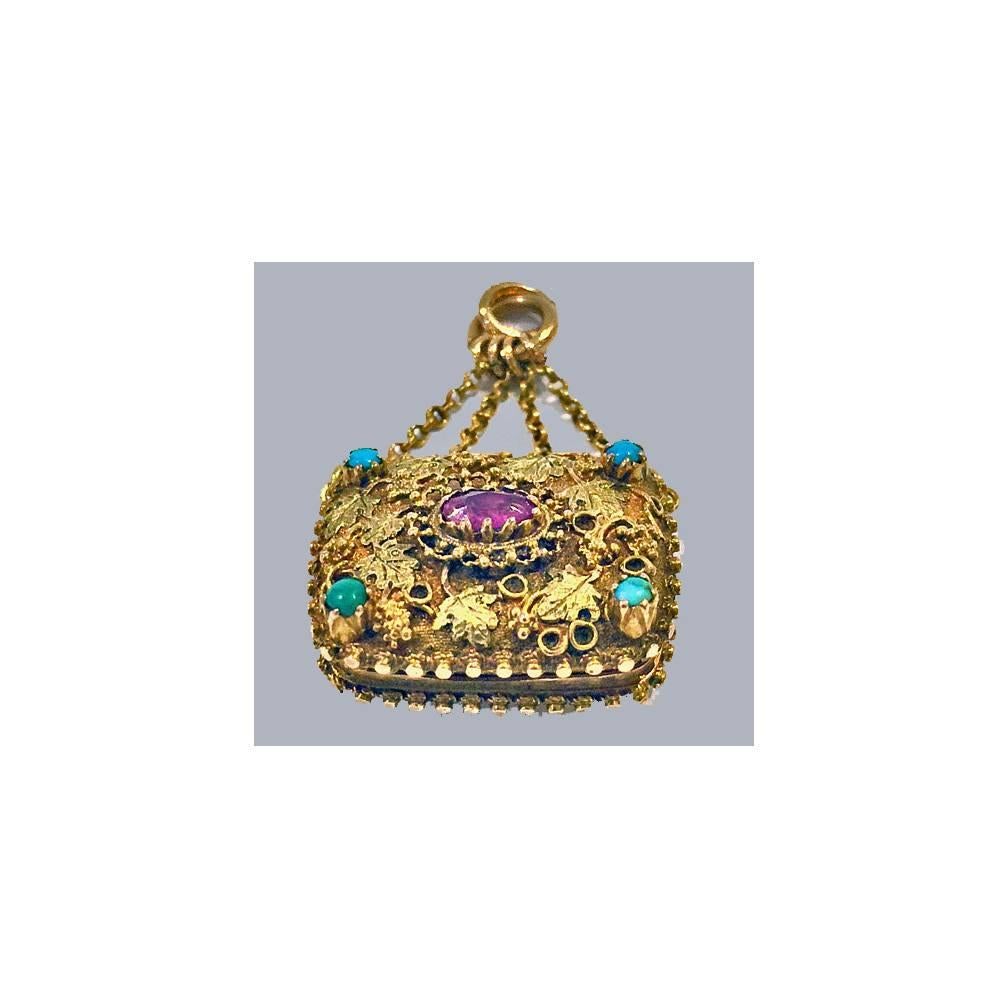 Georgian Gold Vinaigrette, English C.1830. The vinaigrette in the form of a purse bag, the front cannetille decoration with two colour gold foliage and set with pink ruby and turquoise, the reverse with bead star design on stippled background. The