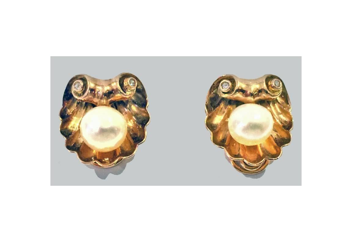 Pair of 18K rose gold cultured Pearl and Diamond Earrings with clip backs, English C.1940. Each of a gold shell design set in the centre with a near round cultured button pearl, gauging approximately 9.5 - 10.0 mm, silver white with rose overtone,