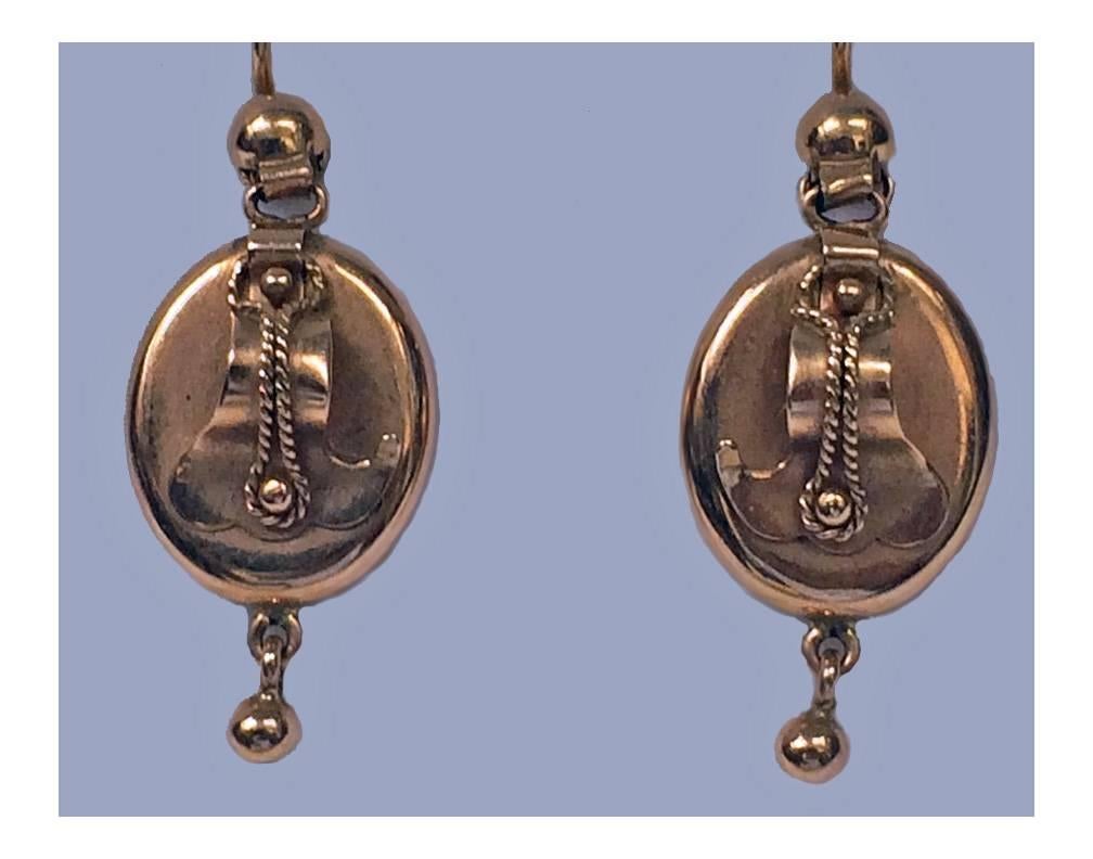 Pair of Russian rose Gold Earrings, Riga C.1960. The drop Earrings of oval form accented with an applied scroll rope surmount, suspending above and below plain polished hemi spherical beads. Shepherd hooks fitments. Each stamped with Russian marks