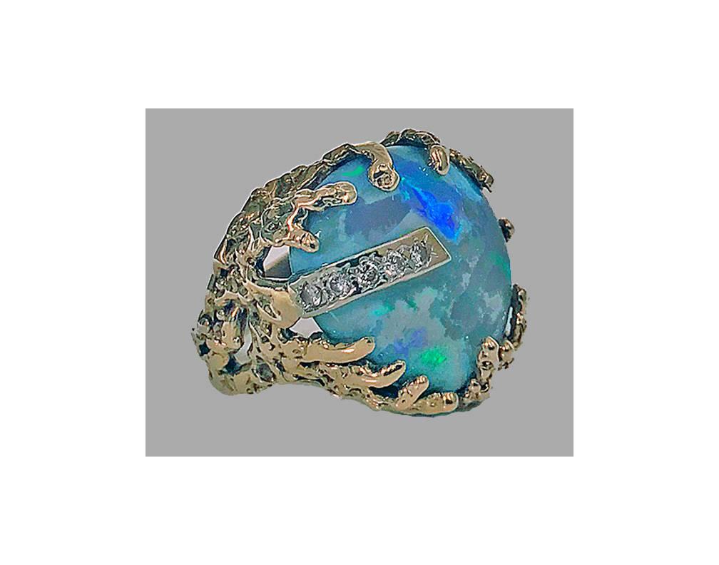 Abstract Opal and Diamond vintage Ring. The ring set with black opal, approximately 18.00 cts, exhibiting iridescent peacock greens and blues; surrounded by gold nugget claw form mount, accented with white gold larger claw set with five small round