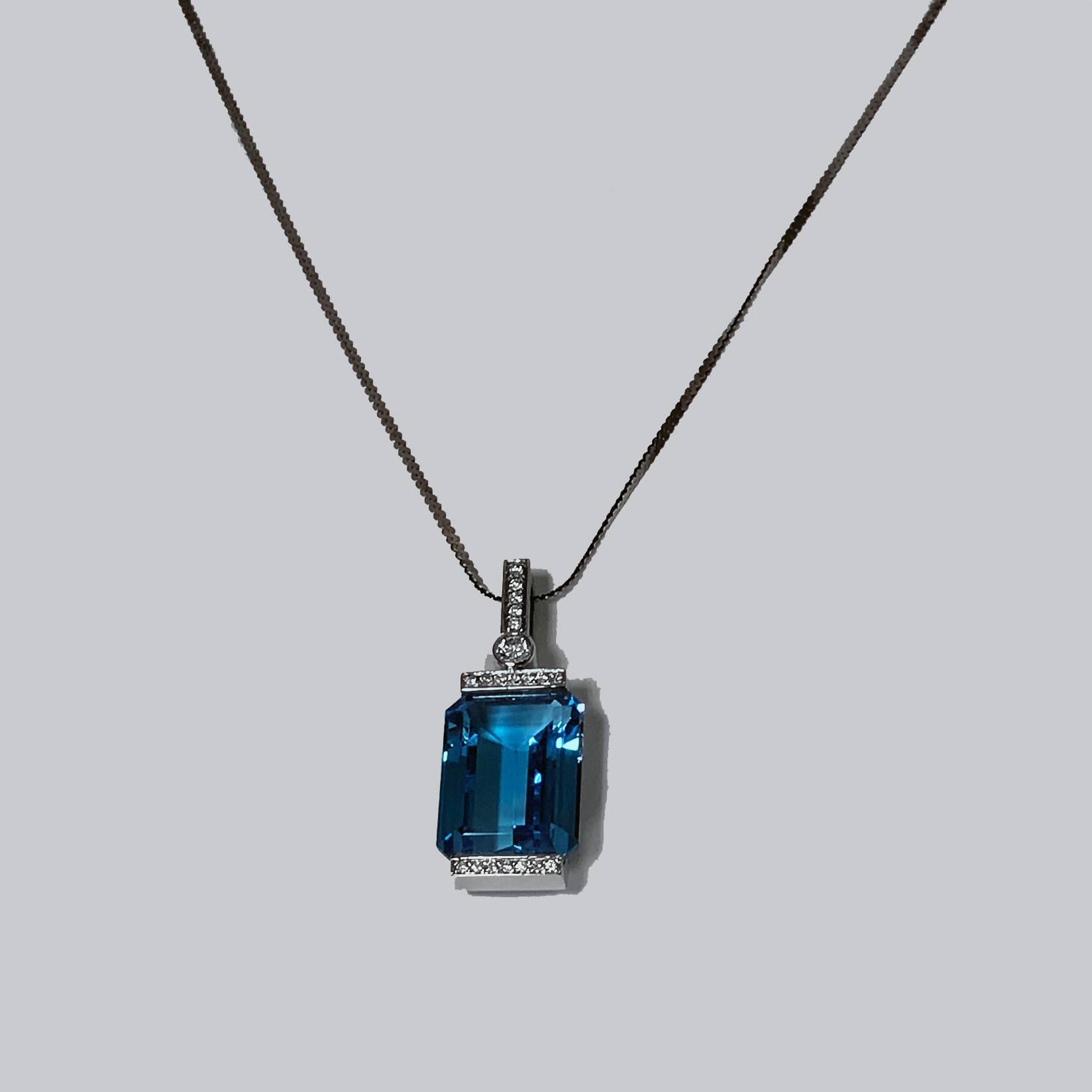 18K white gold mounted Blue Topaz and Diamond Pendant. Rectangular large step cut Blue Topaz accented with small diamonds, 0.48 ct, SI, G, together with 14K white gold chain attached, length 20 inches.