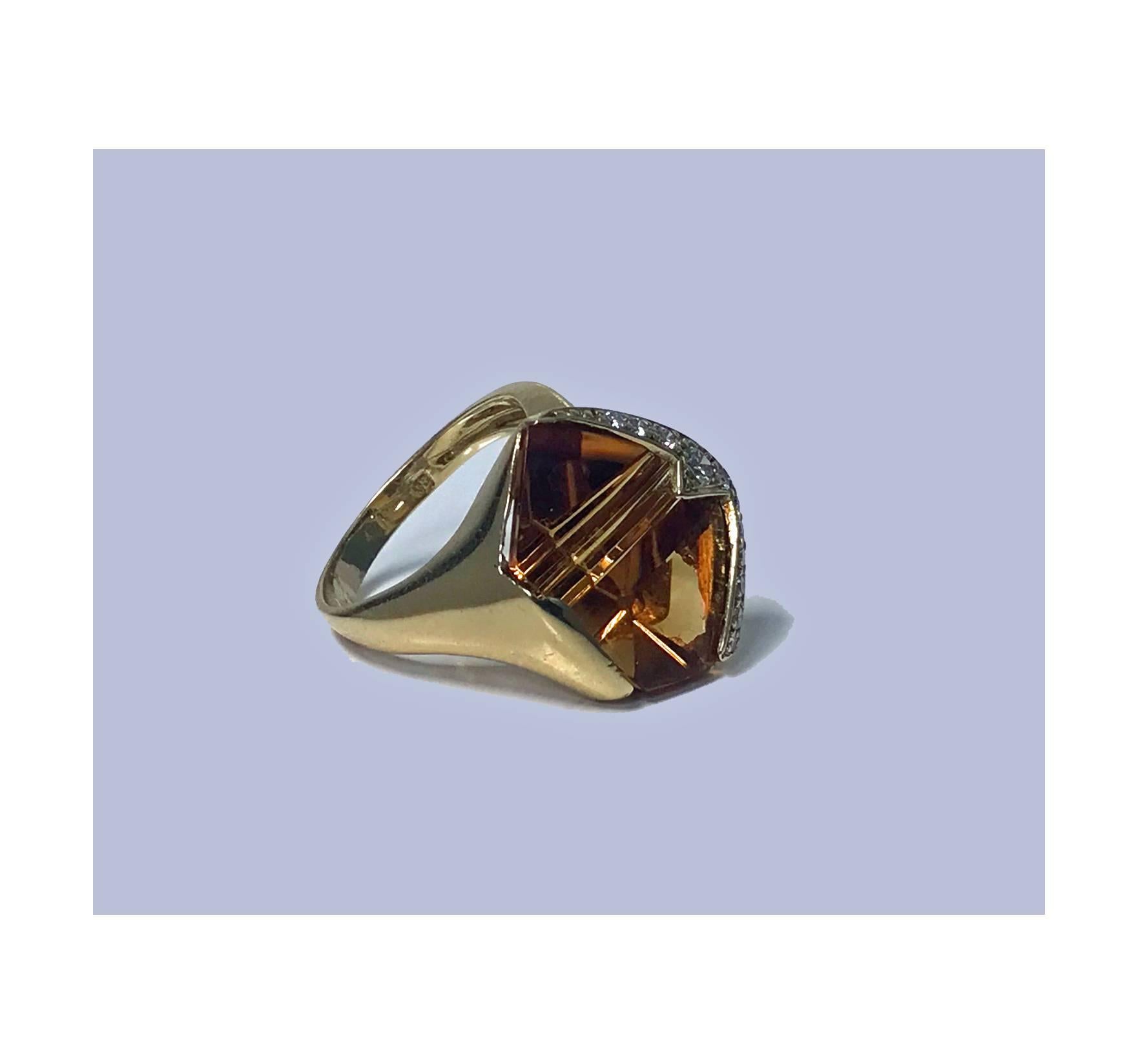 18K Diamond and Citrine Ring. The Ring set with a sherry colour fancy cut citrine, one border contour with eleven small full cut diamonds, channel set within bezel mount. Continental marks and stamped 750. Ring Size: 5.5. Total Item Weight: 7.32