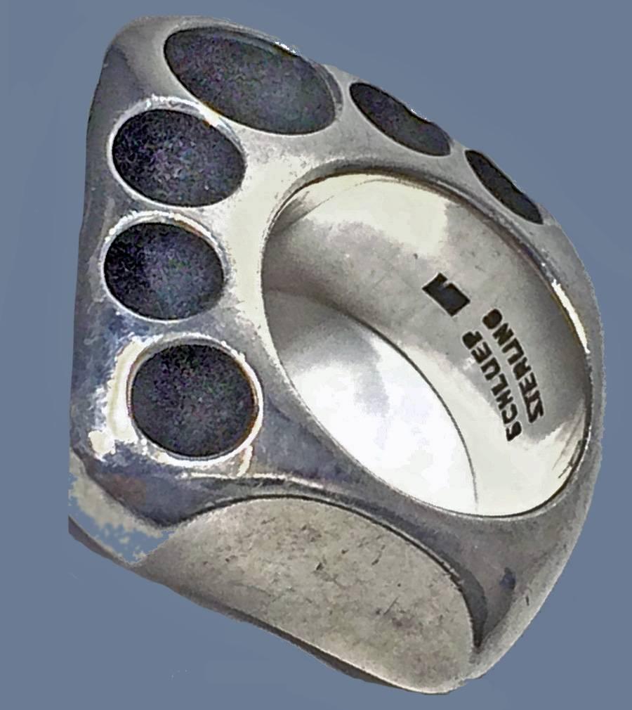 Walter Schluep Sterling Silver Sculptural handmade Ring; asymmetrical with circlet design surround. Measures approximately  31 x 28 mm. Ring size 5. Signed Schluep Sterling. Item Weight: 18.18 grams. Spanish born and Geneva trained, Schluep