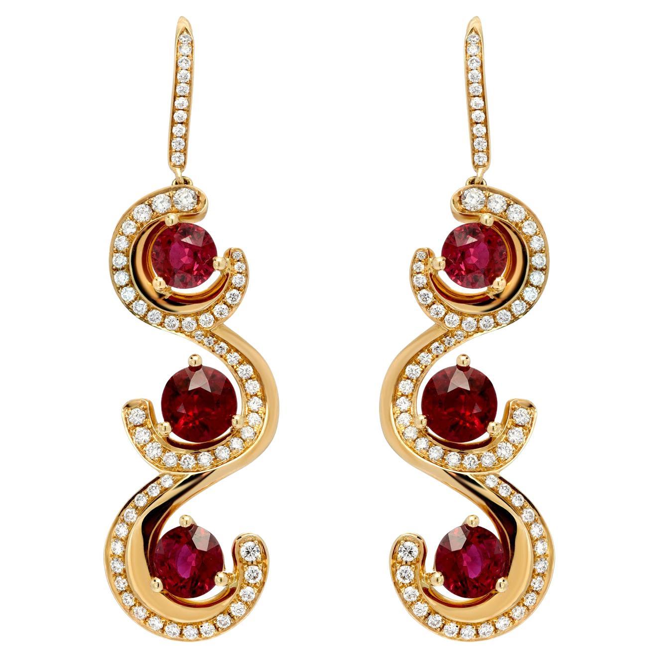 Exceptional Burmese Ruby rounds weighing a total of 7.19 carats, and a total of 1.10 carat round brilliant diamonds are hand set in these spectacular 18K yellow gold earrings. 
Total length - 2 inches
Returns are accepted and paid by us within 7