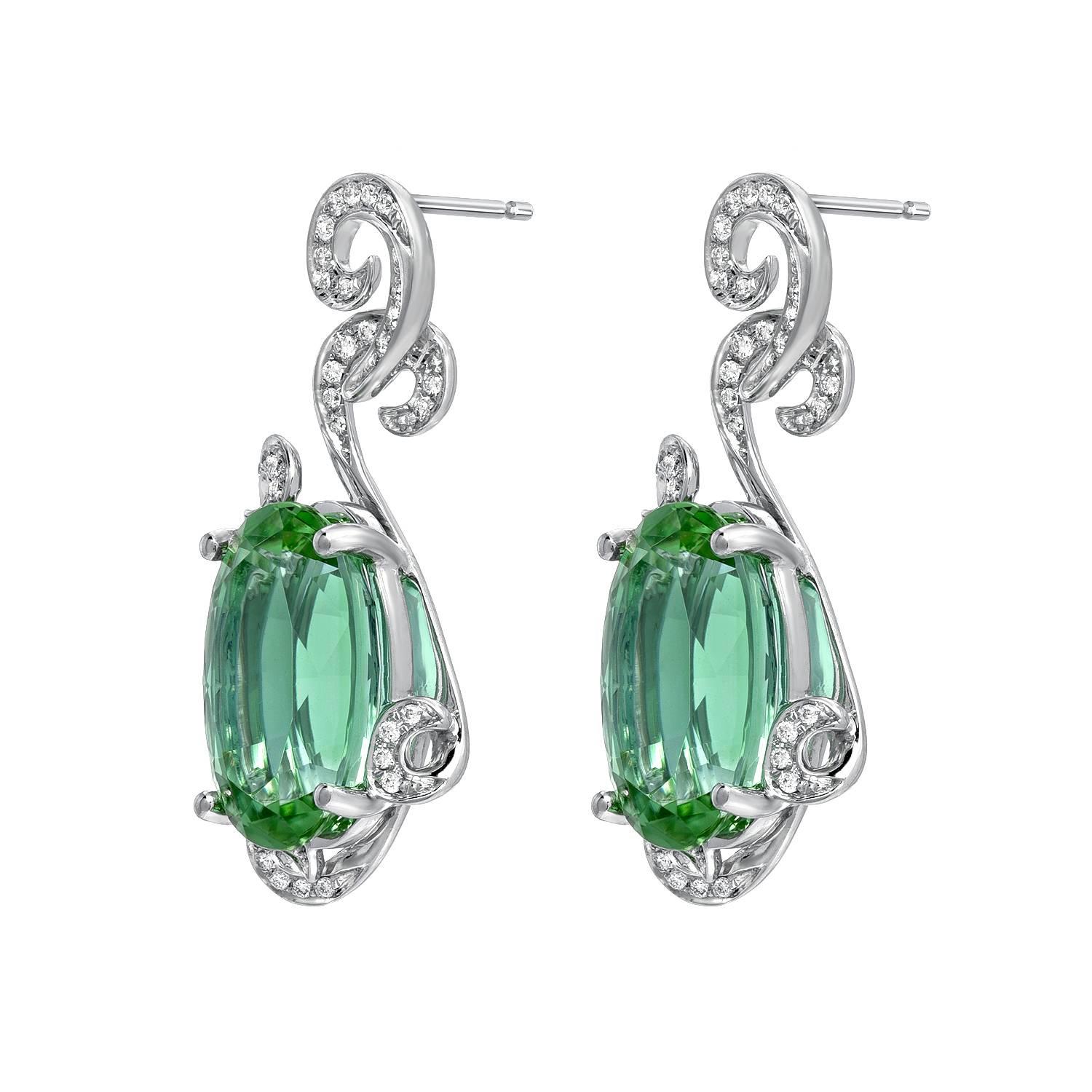 Distinguished pair of 11.66ct total oval Mint Green Tourmaline earrings, accented by a total of 0.23ct round brilliant diamonds.
These 18K white gold earrings are crafted by extremely skilled hands in the USA.
Returns are accepted and paid by us