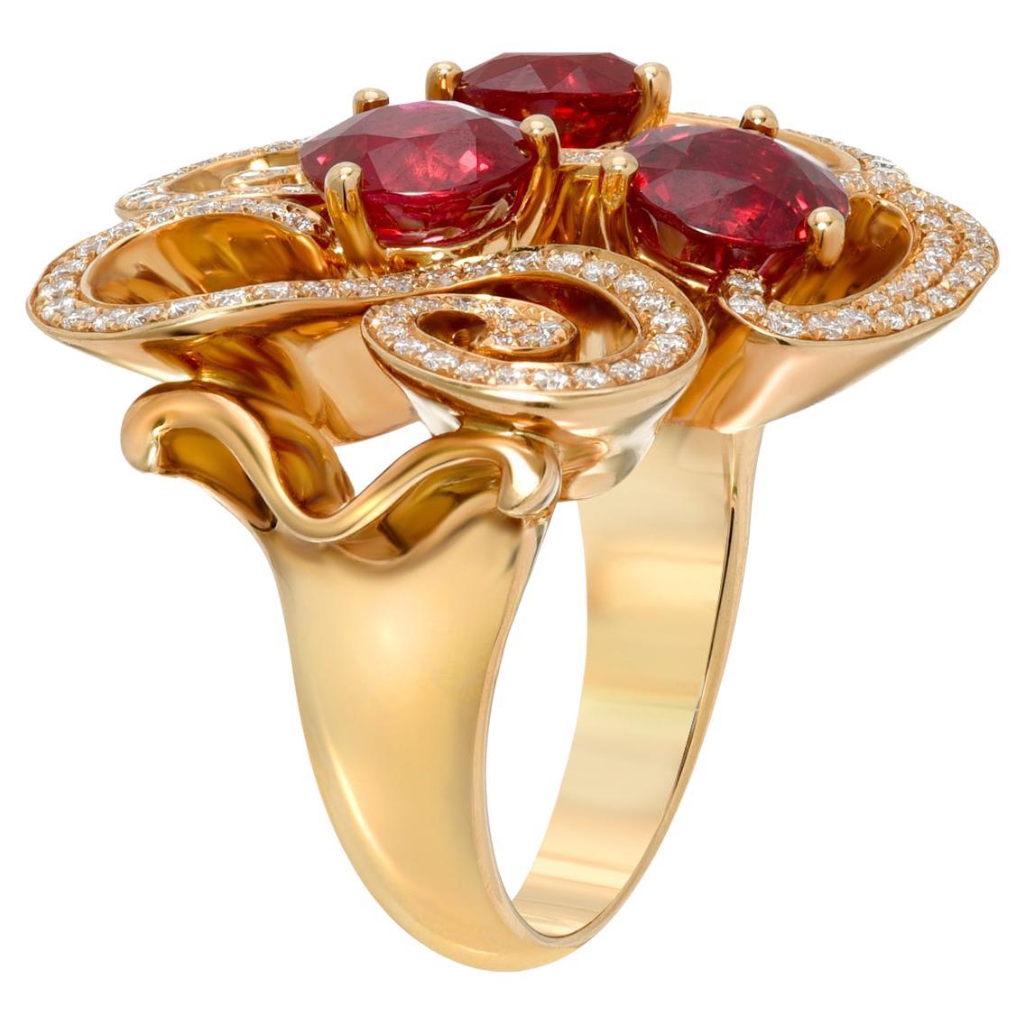 An exceptional trio of round Burma Ruby, weighing a total of 3.82 carats, are surrounded by a total of 0.49 carat round brilliant diamonds, in this magnificent 18K yellow gold Burma Ruby ring.
Size 5.75. Re-sizing is complimentary upon
