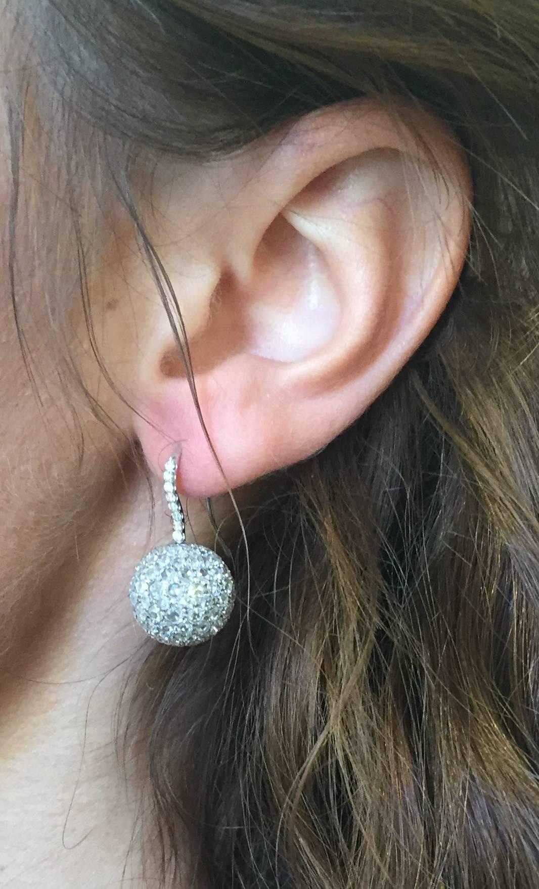 These unique spinning diamond ball earrings are hand-set with a total of 7.03 carats of rose-cut and single-cut diamonds. 
Signed Tamir.
Crafted by hand in the USA.