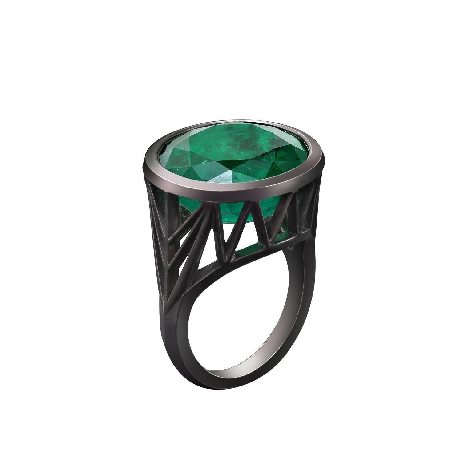 Rock ring from the Stoned collection.
Skeleton of facets holding 15mm round emerald, 11.45cts.  
18ct white gold matt black rhodium plated finish. 
Finger size 50 but can be sized.  
Total weight 9.5 grams.  
Hallmarked Solange Ltd..