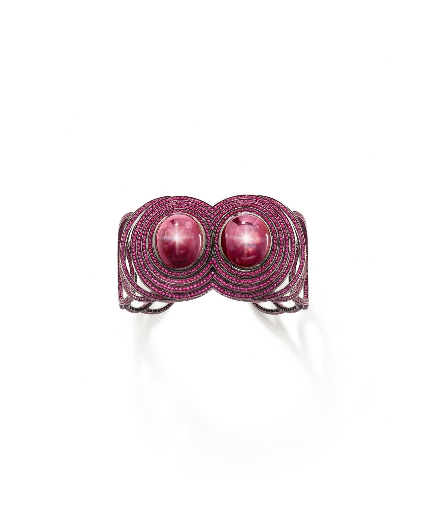 Twin vibration cuff from the Chromance collection. 
Two central star Ruby cabochons totalling 53.20cts creating the vibration and the aftershock vibrations cascading off of the centre. 
Ruby pave covers the vibrations, total Ruby smalls 14.60cts. 