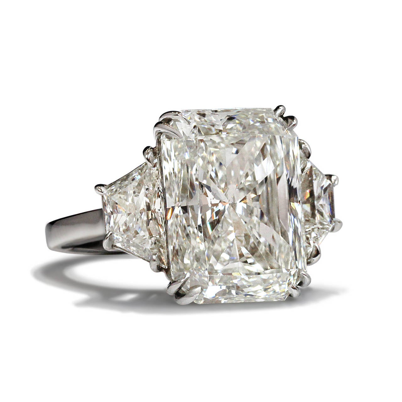 This 12.35ct I VS2 GIA Certified captivating Radiant cut Diamond is set in a hand made Platinum mounting with perfectly matched trapezoids of equal quality. 

David Rosenberg is President of the Diamond Bourse of the Southeastern United States and