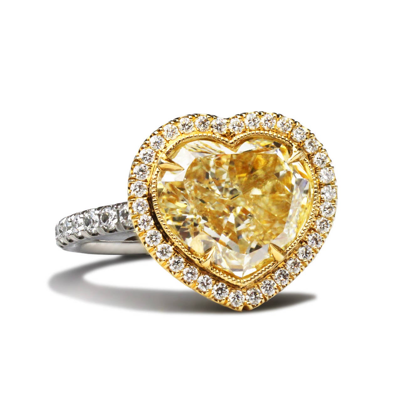 This is a spectacular 18.k yellow diamond ring by David Rosenberg. The center stone is 3.40 ct fancy light yellow with a clarity of VS, GIA Certified. Surrounding the center stone is brilliant round micro pave  having a total weight of .52

David