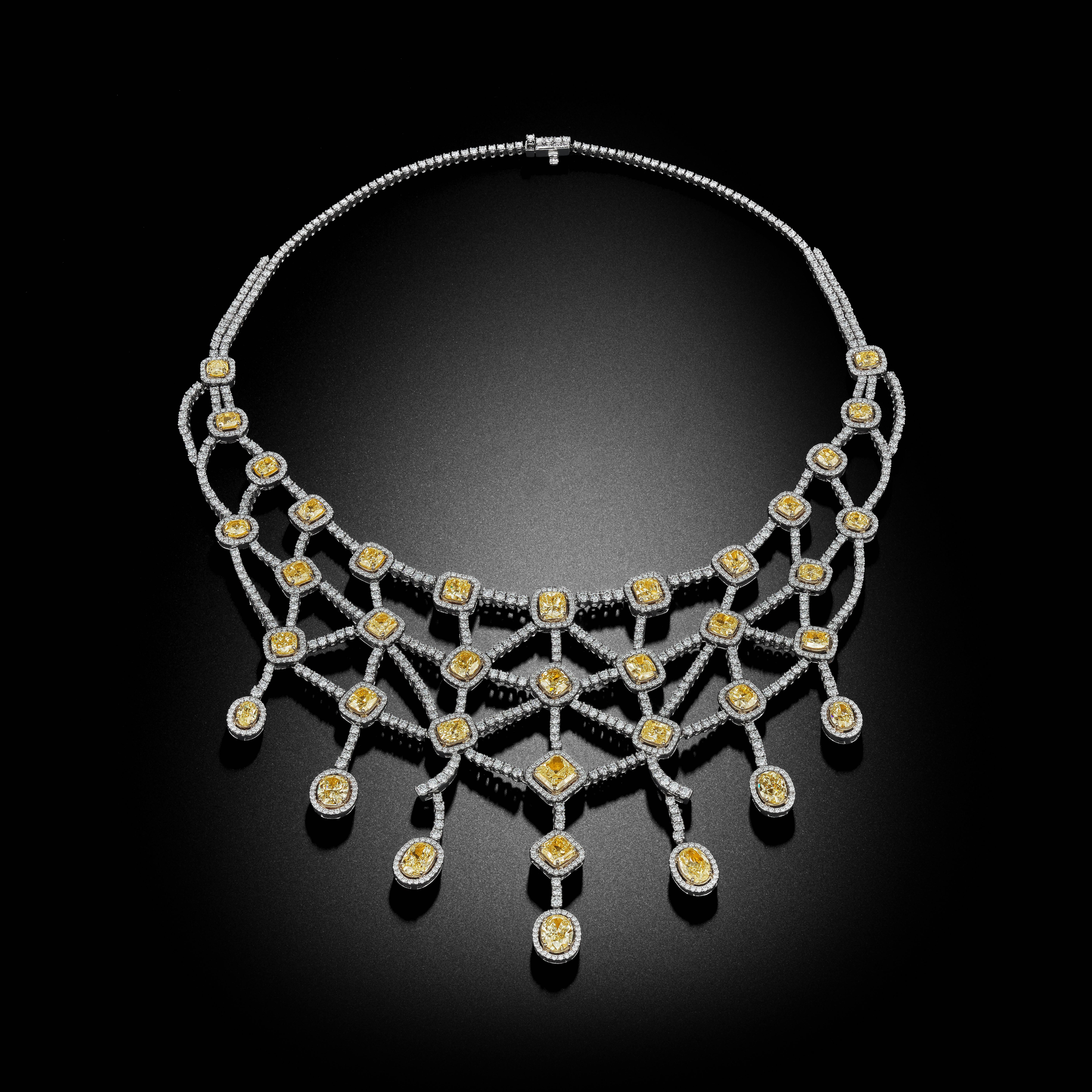 Over 51 Carat total weight of a spectacular White and Fancy Yellow Multi Shape Diamonds are featured in this breathtaking necklace. Set into a design of gossamer 18k white and yellow gold, this masterpiece captures the essence of symmetry and beauty