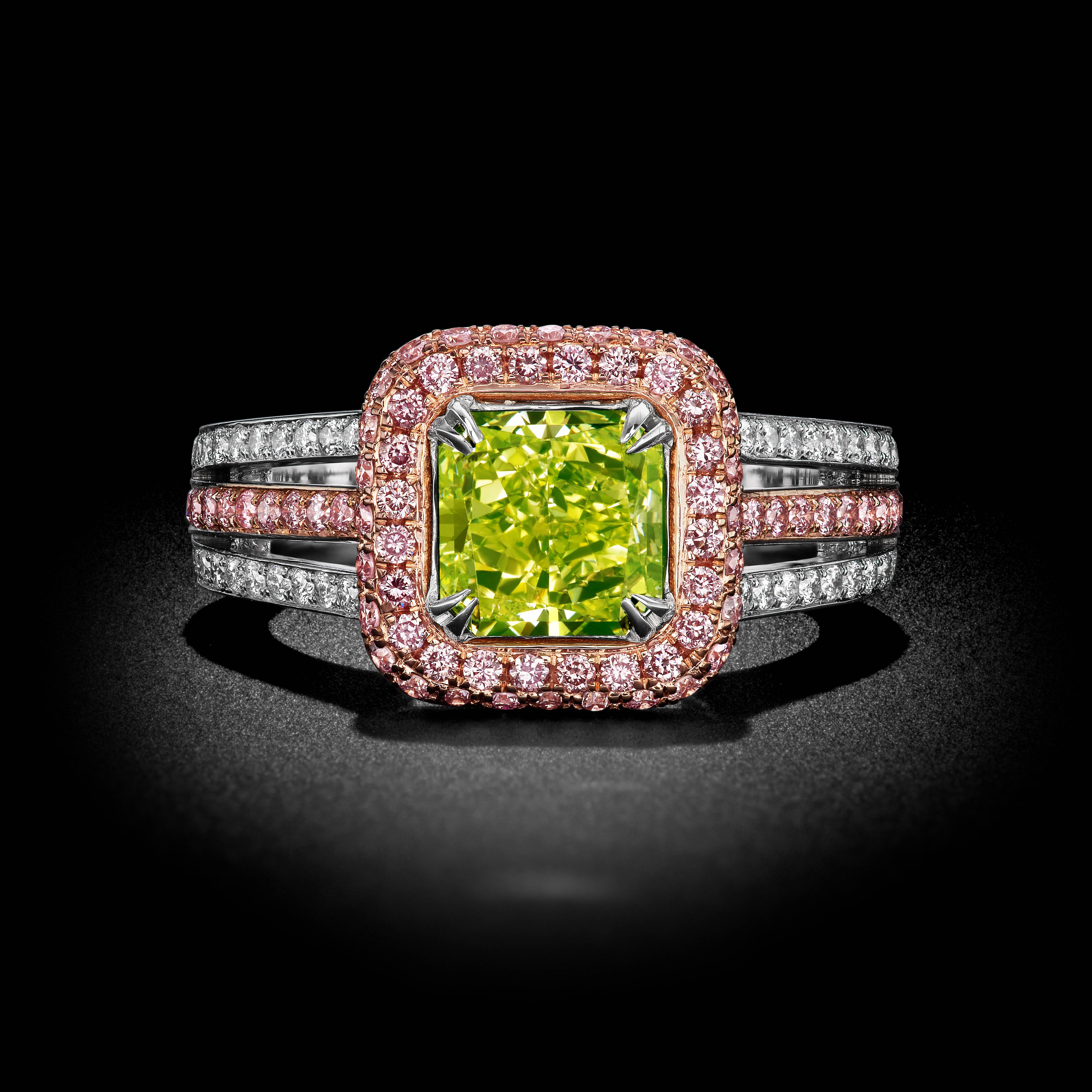 This spectacular Radiant Diamond ring is beautifully set in a hand made 18k white and rose gold setting. The center stone is 1.77ct with a captivating Fancy Intense, Yellow Greenish Color. Accompanied with a GIA Certification. Surrounding the center