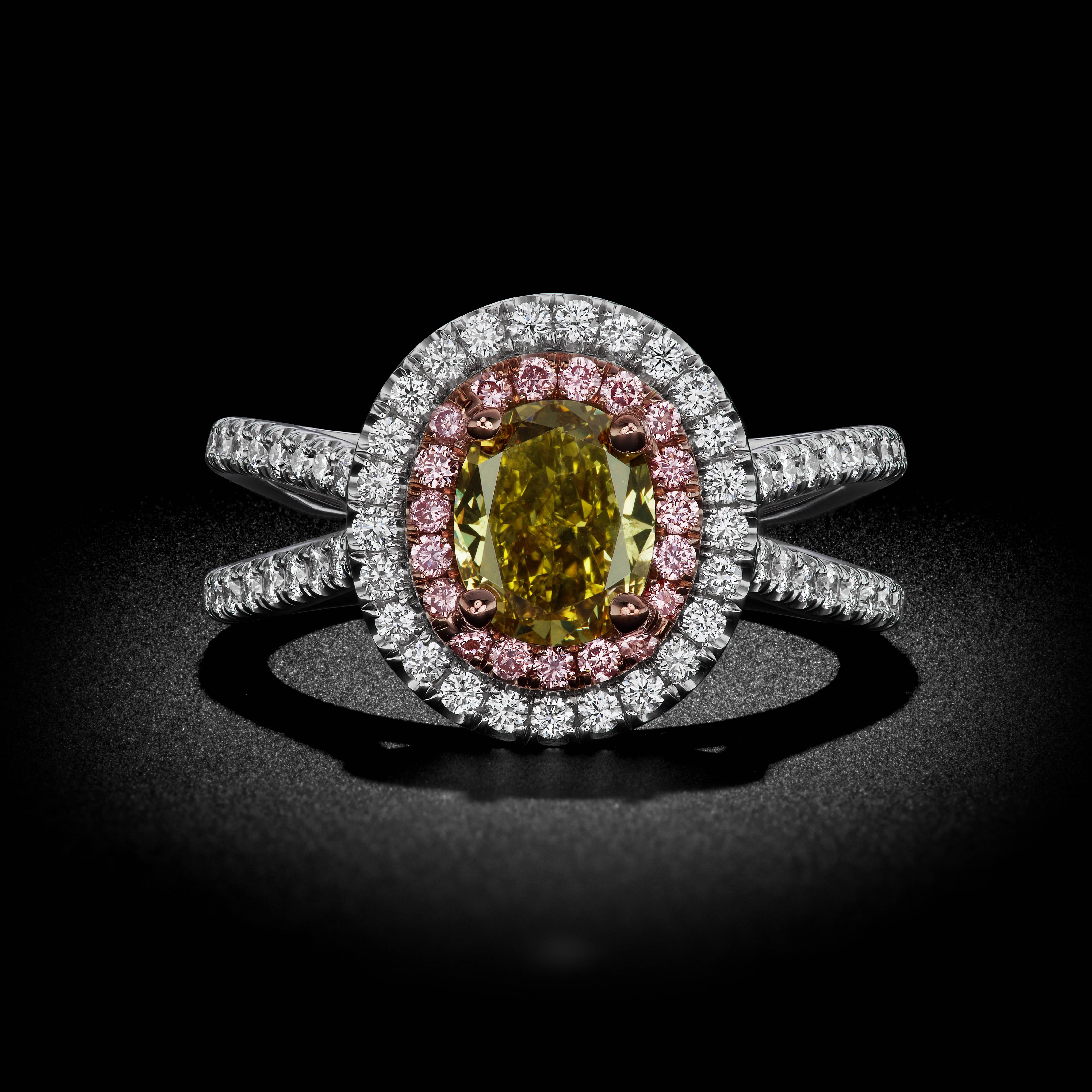 This rare gem shows vibrant shades of Fancy Deep Gray, Green, and Yellow tones in an Oval faceted shape. Accompanied with a GIA Certification. Pink and White diamonds brings this look together with an elegant double halo for a classic and luxurious