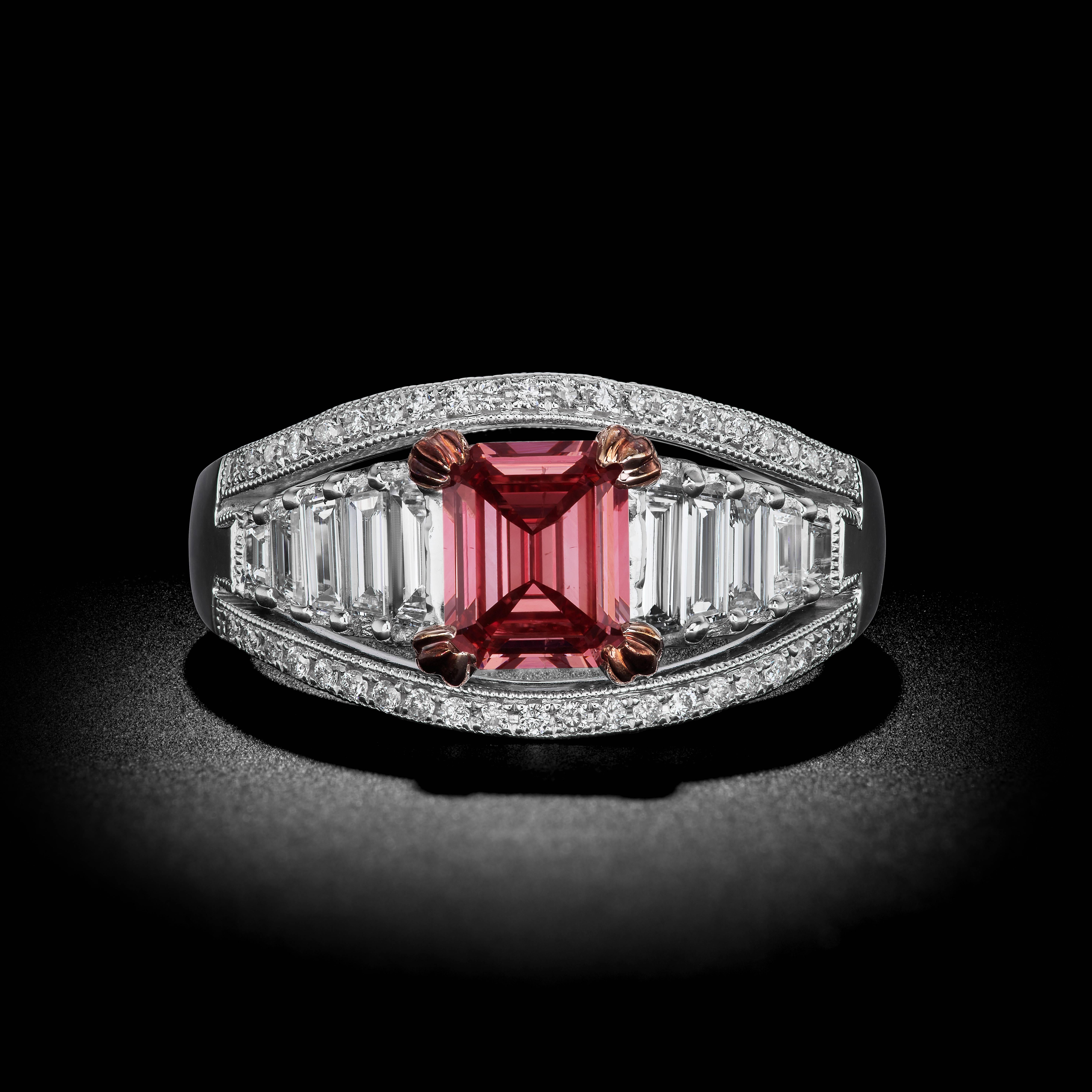 A breath-taking Emerald-cut Diamond ring is featured in this exquisite handcrafted 18k White Gold mounting. The center stone consists of a 1.10 carat Fancy Deep Pink Color. Accompanied with a GIA Certificate.

