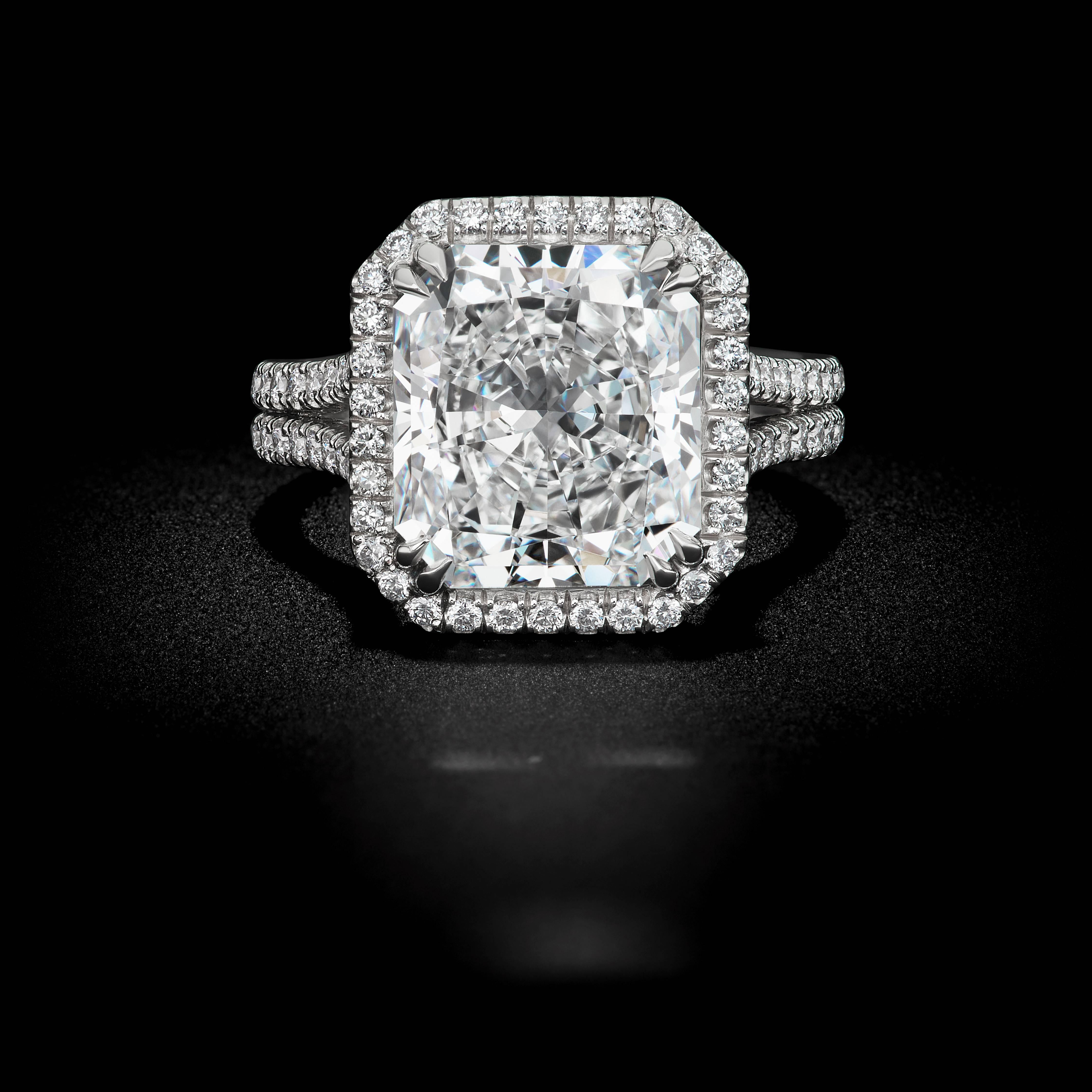 This spectacular 5.52ct Radiant cut diamond ring is set in a beautiful David Rosenberg platinum setting with a color and clarity of E VS1. Along with an elegant micro-pave halo setting with round brilliant diamonds of 1.32tw. This ring is