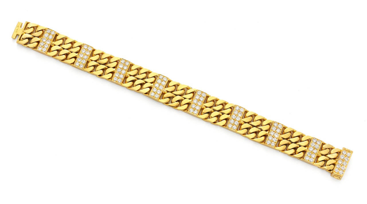An 18kt gold and diamond bracelet, designed as a two row curb link band with pave set diamond panel intersections