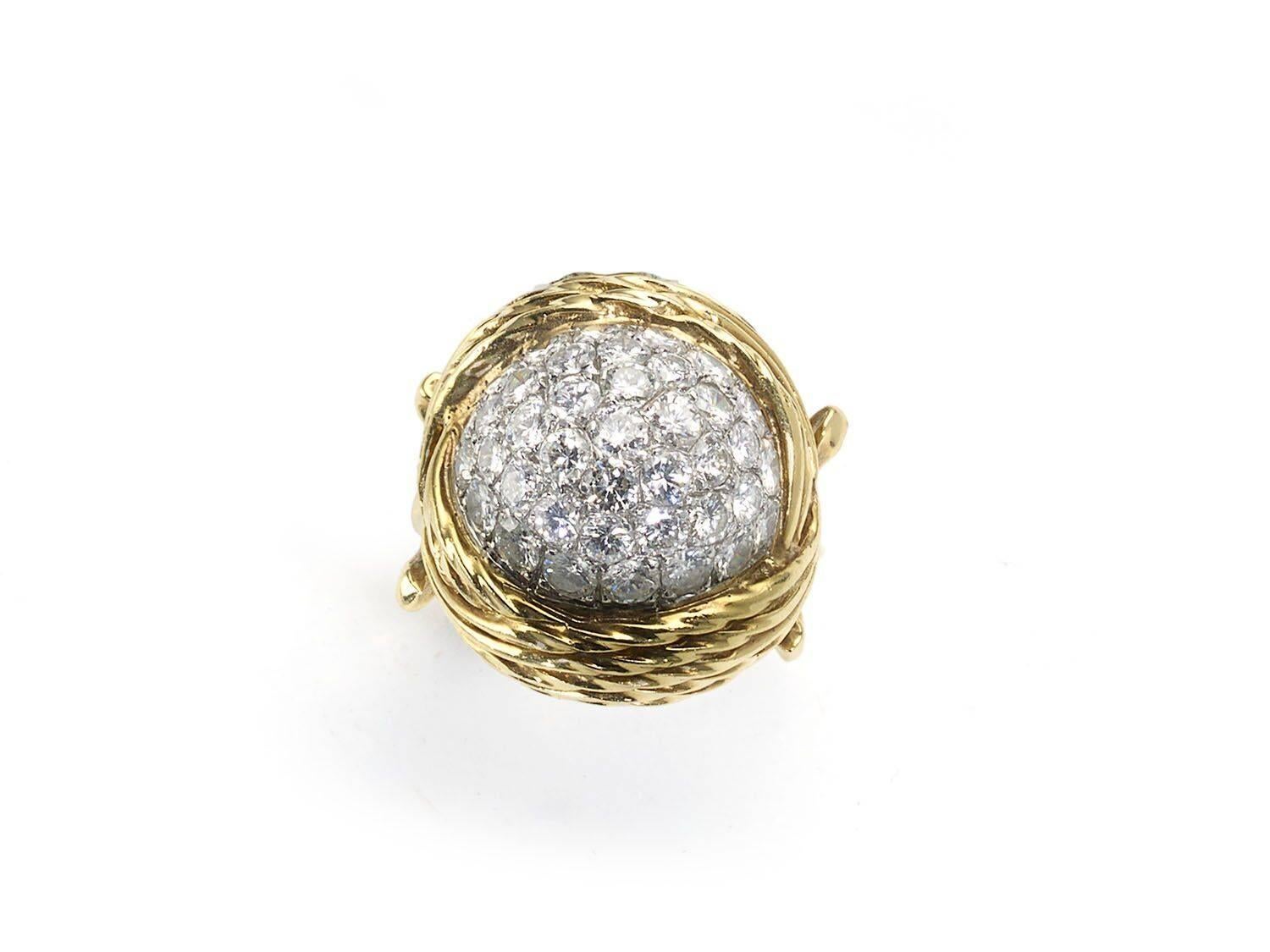 A diamond and gold bombé ring, with a pavé set centre, of round brilliant-cut diamonds, with an estimated total weight of 3.50ct, with a multi-row bark finish surround of twisted wire work, mounted in 18ct gold. Circa 1960s.

Finger size M / USA