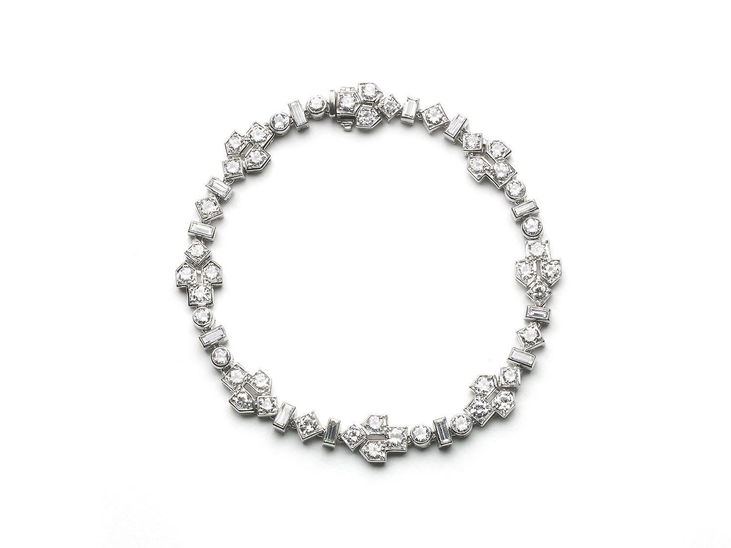 A vintage diamond bracelet, set with baguette, Edwardian and round brilliant-cut diamonds, in rub over settings, mounted in platinum, circa 1950. Estimated total diamond weight 5.60ct