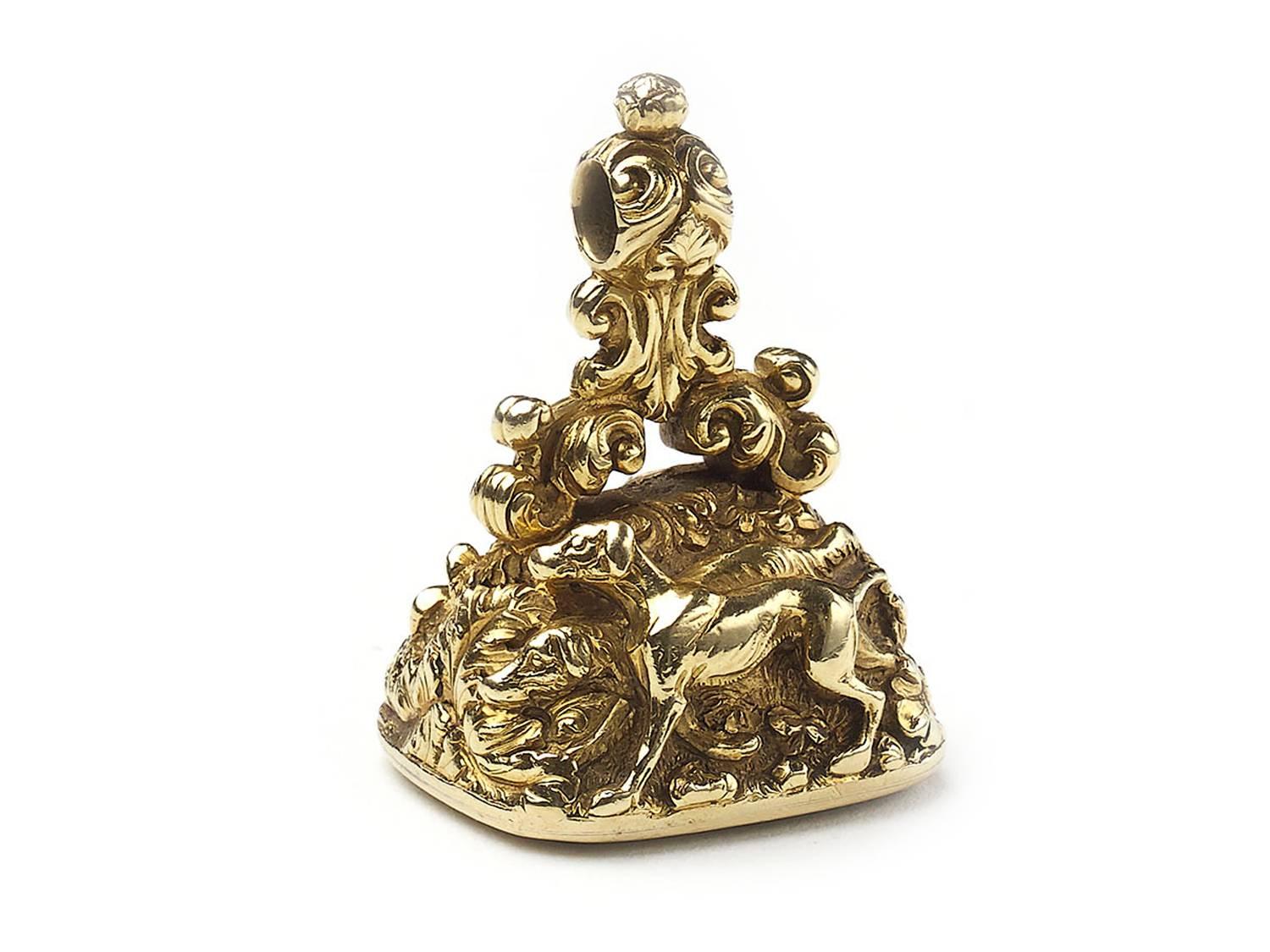A 19th Century hunting fob seal, the carved foliate mount depicting two hound dogs stalking pheasants, mounted in 15ct yellow gold. Length approximately 4.2 cm