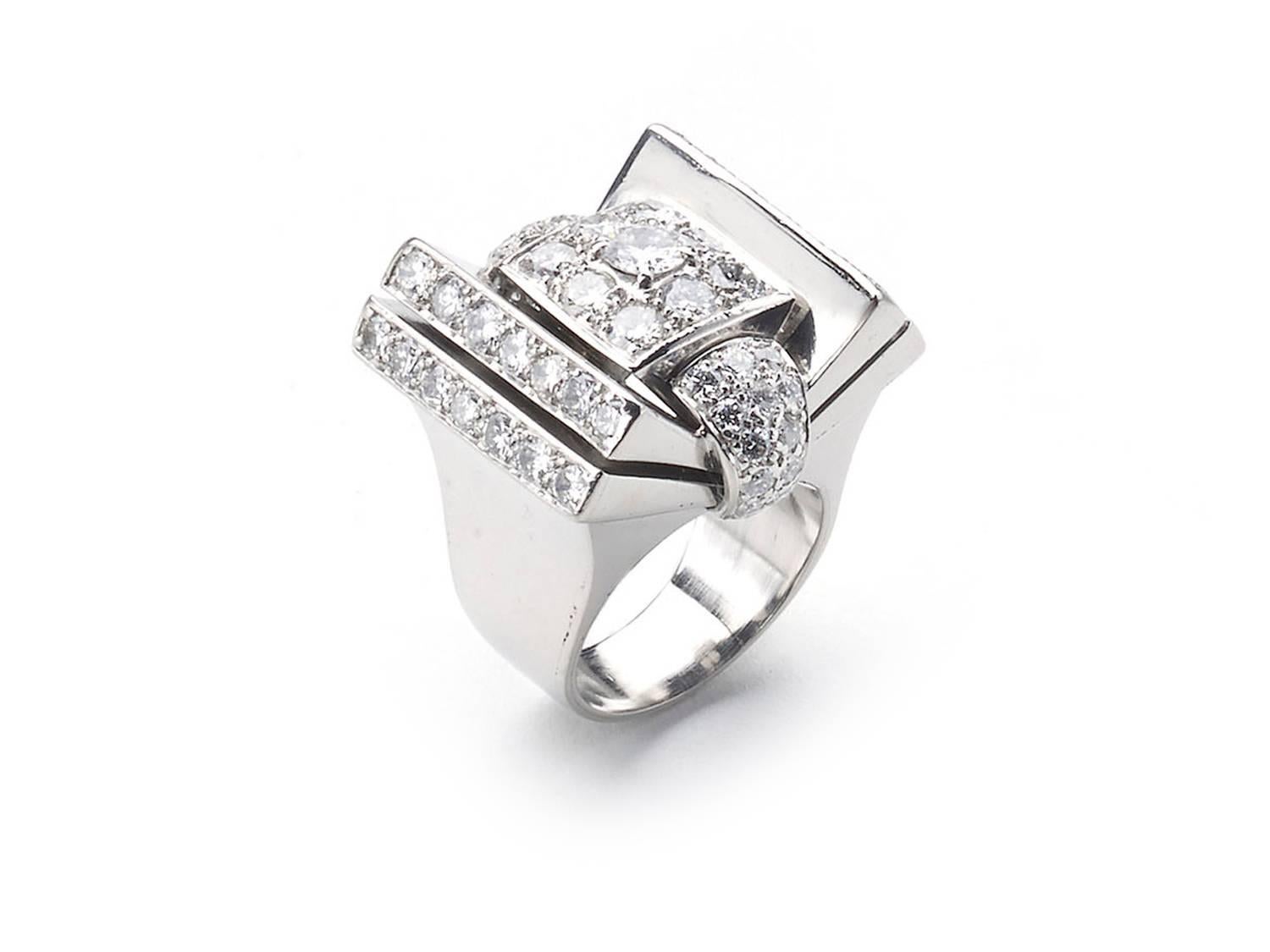 A vintage diamond cocktail ring, with a central square, set with round brilliant-cut diamonds, in pavé settings, with pavé set diamonds above and below, curving round two layers, like pages of a book, the edges of which are pavé set with round