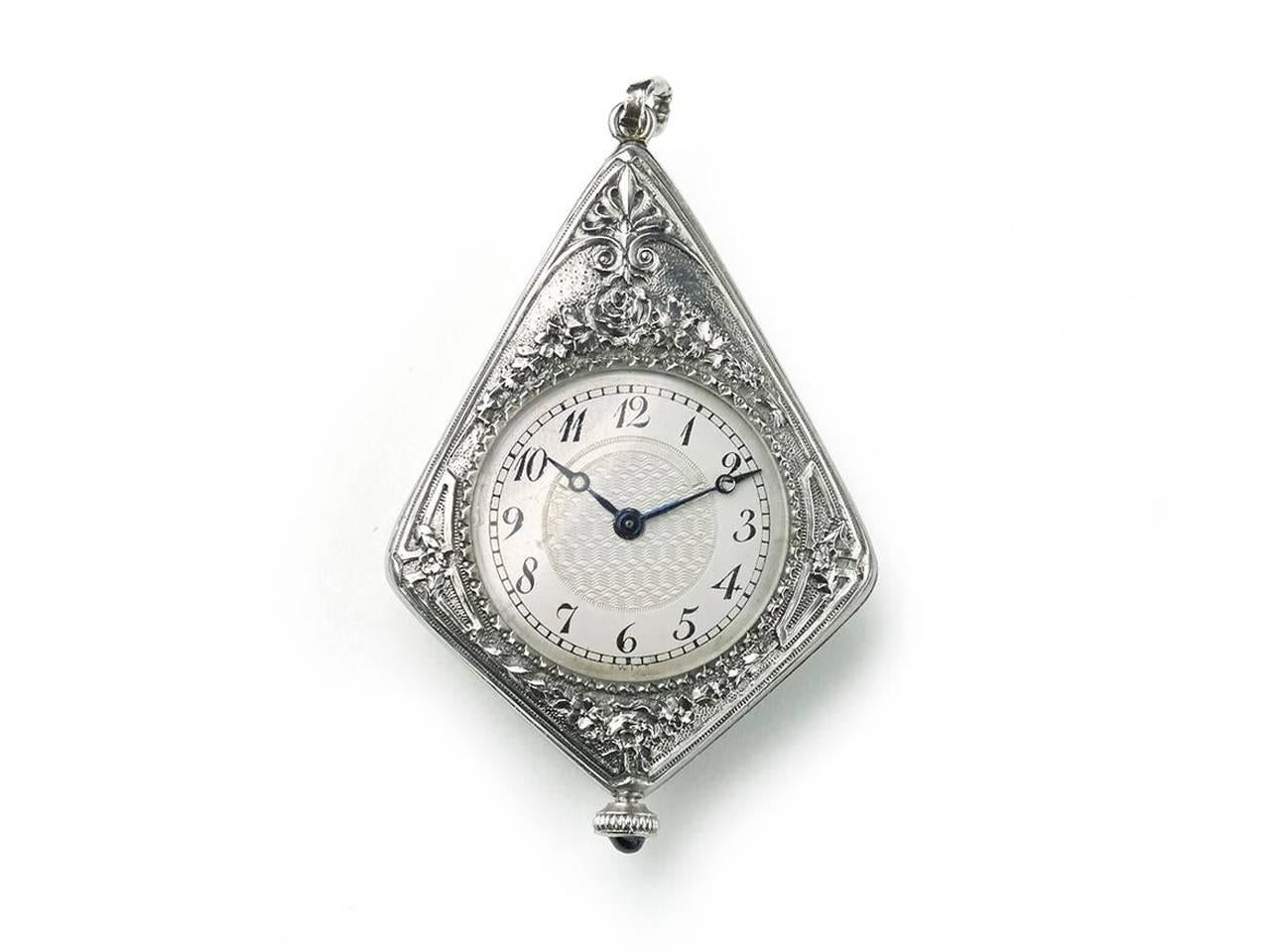 An Art Deco watch pendant, with blue guilloche enamel, with a thistle design within an ace motif, in the centre, set with old-cut and rose-cut diamonds and a foliate engraved and old-cut diamond set surround, on the other side is a watch, with a