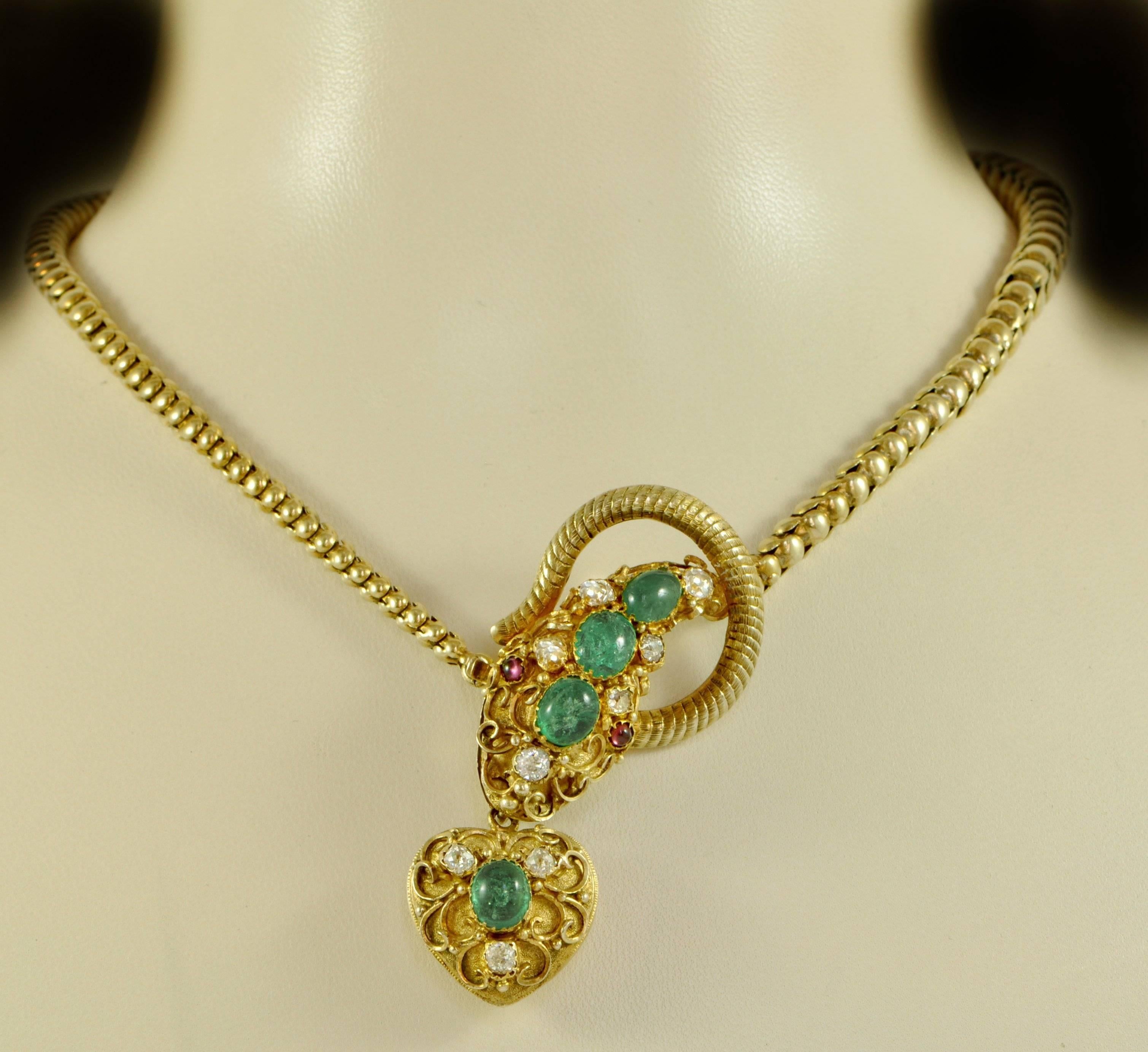 A Victorian 15ct gold snake necklace, set with cabochon emeralds and diamonds, with cabochon ruby eyes.
