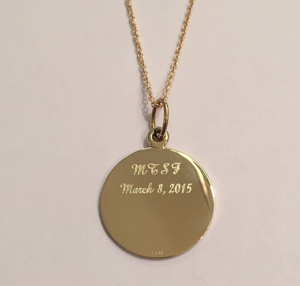 Personalized 14kt Gold First Communion Pendant Necklace.

Gold circle pendant laser inscribed with your Church/School Logo and then engraved with your child's initials, or monogram and Date of the First Communion or Confirmation.

The Pendant is