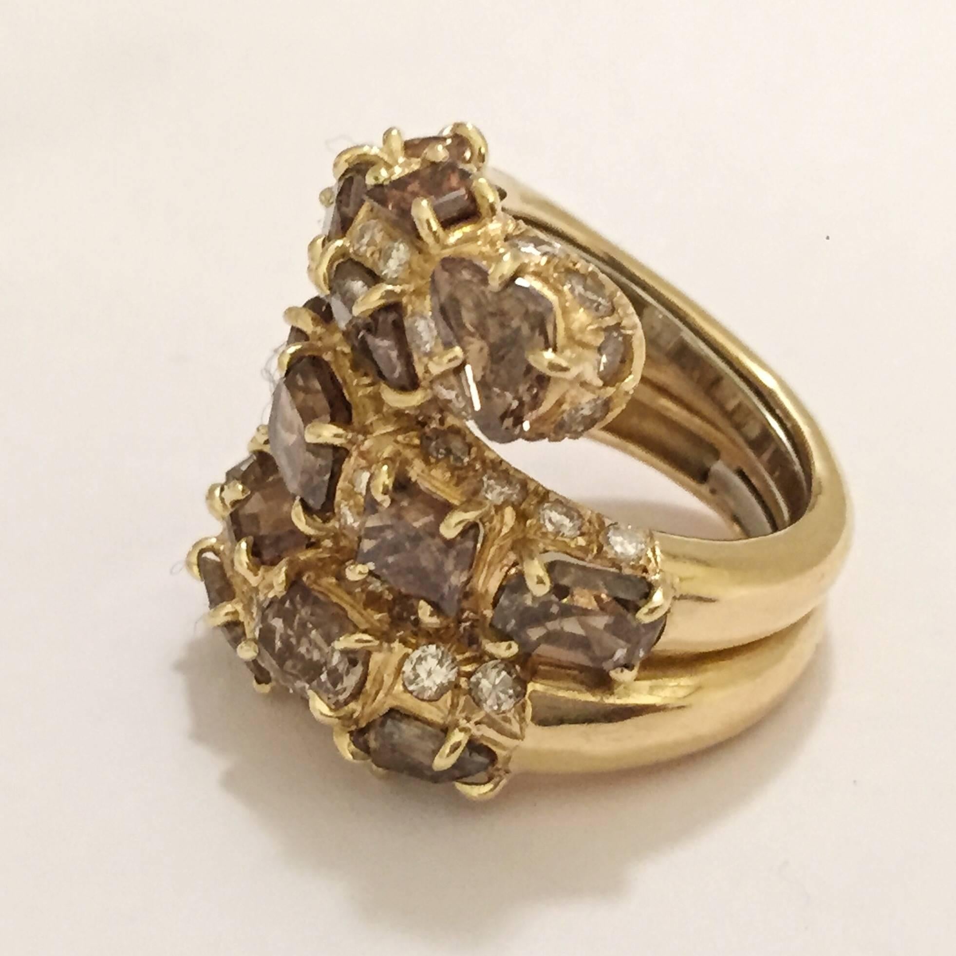 18kt Yellow Gold Modern Swirl Ring with multi shaped Brown Diamond slices and Round brilliant Brown Diamond Detail.  The Brown Diamond weight is approximately 13 carats total weight.    The Yellow Gold weight is approximately 14 dwt.

This is a