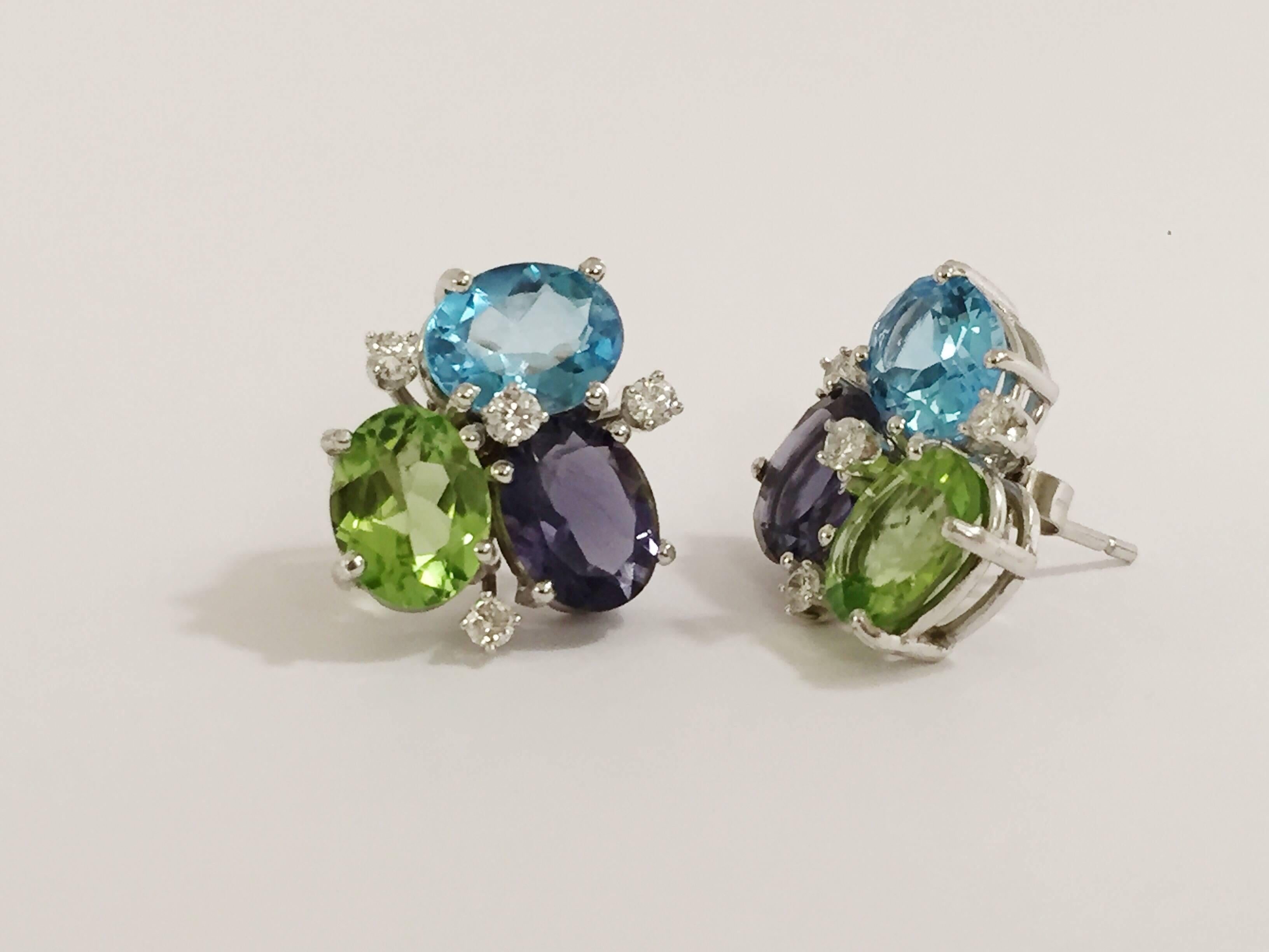 18kt White Gold Blue Topaz, Peridot, Iolite and Diamond Mini Pebble Earring.  

This elegant mini cluster combines faceted oval Blue Topaz,  Peridot and Iolite with the sparkle of 8 diamonds weighing approximately 0.25 cts  

The earrings