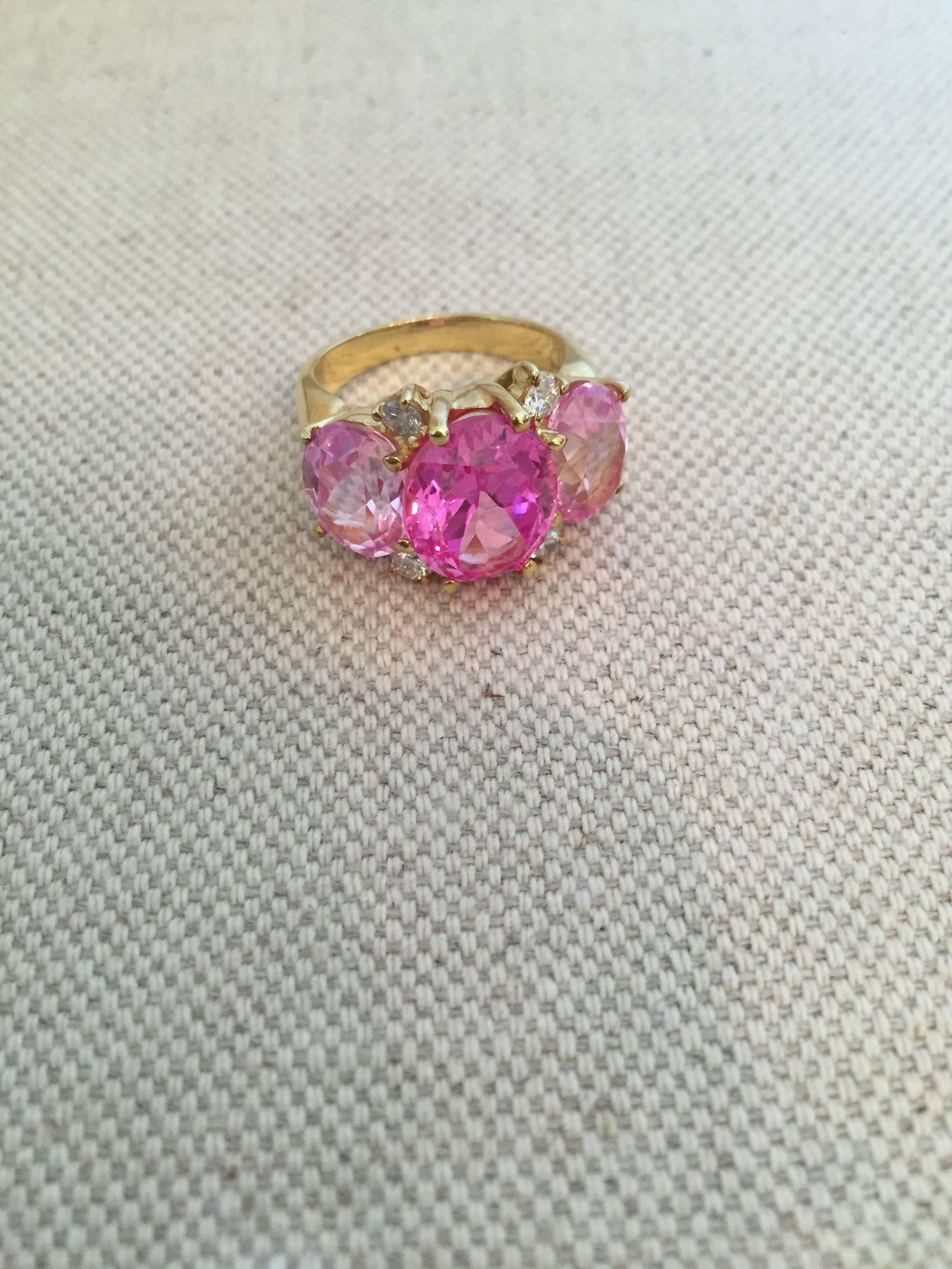 18kt Yellow Gold Medium GUM DROP™ Ring with faceted oval shaped center Pink Topaz and two oval faceted Pink Topaz and four round Diamonds ~0.50cts

The Ring measures ~ 1